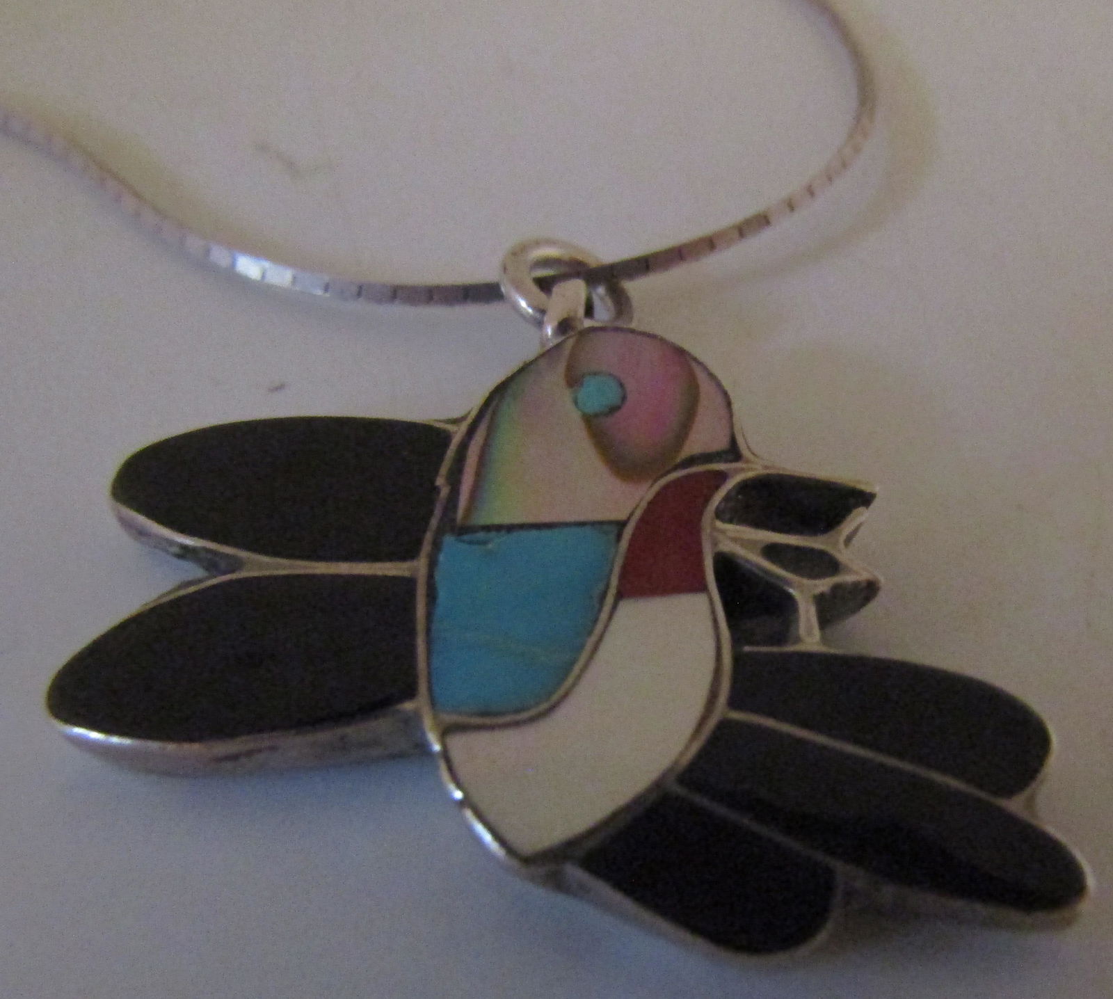 ELLA GIA INLAY NECKLACE STERLING SILVER HUMMINGBIR: SIGNED "ELLA GIA" HUMMINGBIRD ABALONE, MOP ONYX, CORAL & TURQUOISE NATIVE AMERICAN SOUTHWEST ZUNI INDIAN JEWELRY. PENDANT 28MM BY 35MM. LINK CHAIN MEASURES 20 INCHES LONG. WEIGH 7.6 GRAMS. EXCELLENT U
