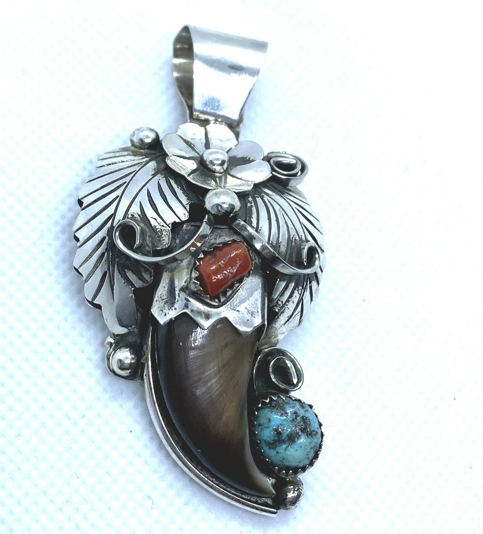 JERRY THOMPSON BEAR CLAW STERLING PENDANT: NATIVE AMERICAN RED CORAL AND TURQUOISE PENDANT. SIGNED MARKED JT STERLING. TESTED STERLING SILVER. HEIGHT 2-1/2" WITH BAIL AND 1-3/8" WIDE. BAIL FITS 7MM NECKLACE. WEIGHS 16.5 GRAMS. USA SHIPPING $5.