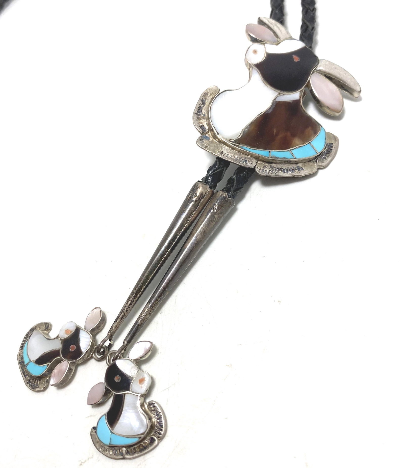 SIGNED QUALO ZUNI STERLING STEER BOLO TIE: NATIVE AMERICAN ZUNI ARTISAN HANDMADE PIECE. SIGNED MARKED "D QUALO ZUNI" TESTED STERLING SILVER. COW BONE HORNS MOTHER OF PEARL BROWN ONYX RED CORAL EYES AND TURQUOISE STONES. WEIGHS 40 GRAMS TOTAL W