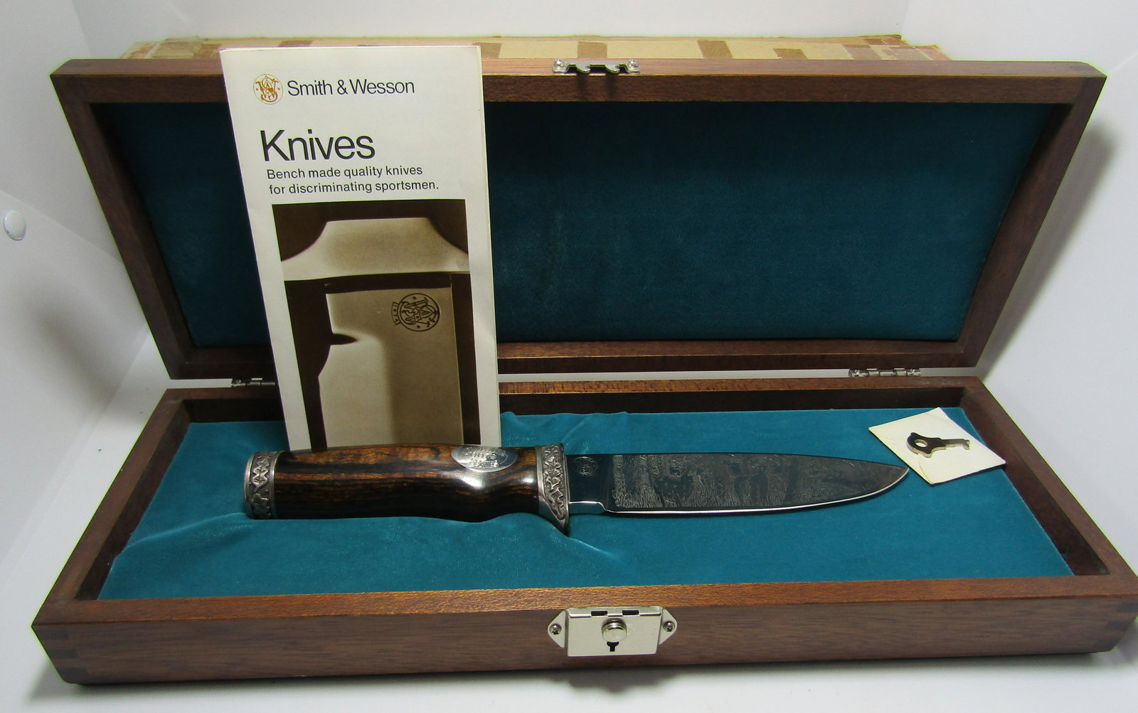 CUSTOM SMITH & WESSON ENGRAVED KNIFE: S&W KNIFE CUSTOM ETCHED AND ENGRAVED BY WALTER "BLACKIE: COLLINS for SMITH AND WESSON # 0079 OUT OF 1000. WILDLIFE SCENE. COMES WITH MAHOGANY BOX, KEY, AND PAPERS. 10 INCH KNIFE WITH 5 1/4 INCH BLADE.