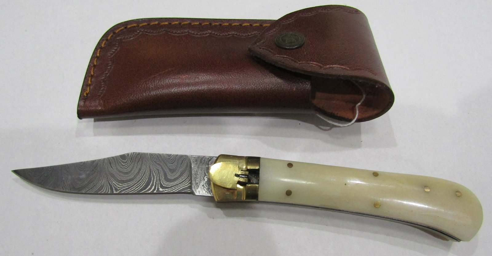 SWITCHBLADE DAMASCUS KNIFE: 9 INCH LEVERLETTO STYLE PUSH BUTTON SWITCH WITH 4 INCH DAMASCUS BLADE AND 5 INCH BONE GRIP HAS A LEATHER SHEATH. USA SHIPPING $5.