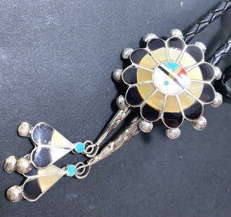 STERLING ZUNI SUNFACE TURQUOISE BOLO TIE: NATIVE AMERICAN ZUNI HANDMADE PIECE. UNIQUE STERLING FEATHER END TIPS. MARKED "ZUNI SS" TESTED STERLING SILVER. WEIGHS 23 GRAMS WITH LEATHER. DIAMETER 1-3/8". NECKLACE IS 38". USA SHIPPING $5.
