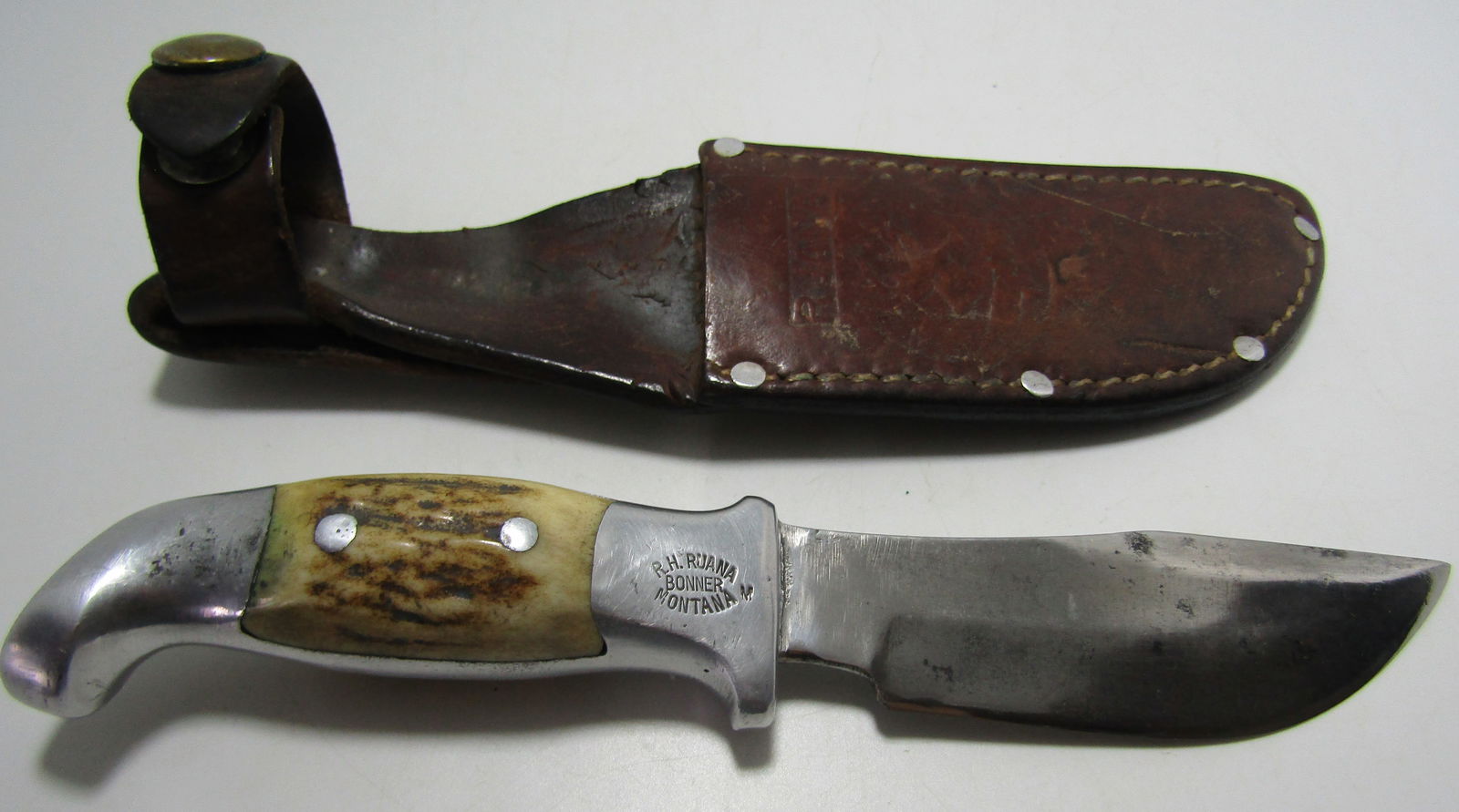 VINTAGE RUANA HUNTING KNIFE WITH SHEATH: VINTAGE R H RUANA HUNTING KNIFE WITH M MARK. 8 INCH WITH 4 INCH BLADE WITH ORIGINAL LEATHER SHEATH. USA SHIPPING $5.