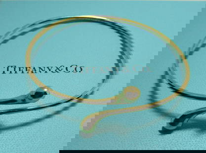 TIFFANY & CO 18K GOLD BANGLE BRACELET ELSA PERETTI: GENUINE SIGNED "TIFFANY & CO. PERETTI 750 SPAIN". FITS A 7 INCH WRIST. WEIGHS 14.1GRAMS. EXCELLENT VINTAGE ESTATE CONDITION. WITH TIFFANY BOX. USA SHIPPING $5.