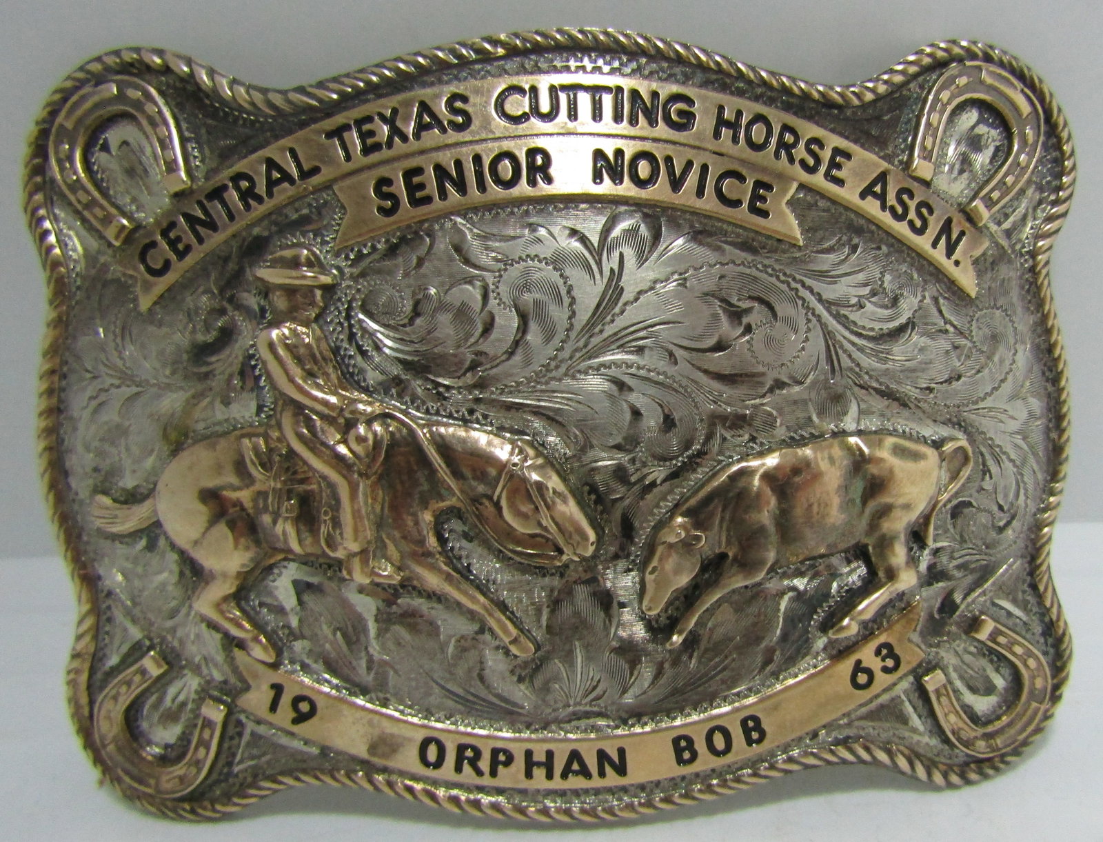 NELSON SILVIA STERLING 10K GOLD RODEO BUCKLE BELT: "1963 ORPHAN BOB CENTRAL TEXAS CUTTING HORSE ASSN SENIOR NOVICE" BY "NELSON SILVIA CO STERLING 10K HOUSTON" VINTAGE ESTATE BROWN LEATHER MEASURES 39 INCHES LONG OVERALL BY 1 5/8" WIDE. WILL FIT 31 TO 