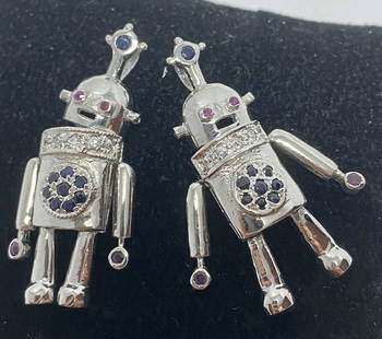 2 STERLING 3D MOVABLE ROBOT CHARM PENDANTS: RUBY SAPPHIRE CZ ENCRUSTED. MARKED ISCTH 925. TESTED STERLING SILVER. ARMS LEGS AND HEAD MOVE. 10 GRAMS TOTAL SO 5 GRAM EACH. USA SHIPPING $5. NO INTERNATIONAL SHIPPING OUTSIDE THE USA.