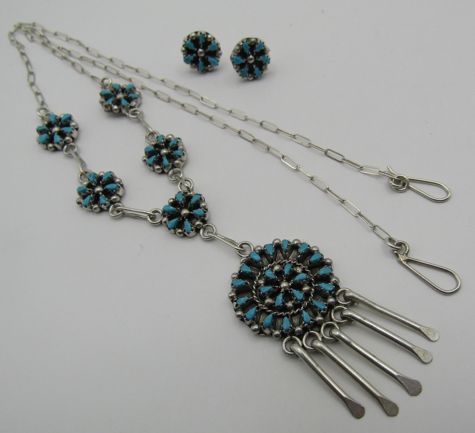 "TL" PETITPOINT TURQUOISE NECKLACE EARRINGS SILVER: ARTIST HALLMARKED "TL STERLING". NATIVE AMERICAN SOUTHWEST NAVAJO INDIAN JEWELRY. NECKLACE MEASURES 19 INCHES LONG PLUS 2 1/2" BY 1" TURQUOISE DROP. EARRINGS MEASURE 10MM WIDE. TOTAL WEIGHT 14.0 GRAMS