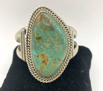 61 GRAM STERLING TURQUOISE NAVAJO CUFF BRACELET: NATIVE AMERICAN NAVAJO HANDMADE PIECE. GORGEOUS WATERWEB SPIDERWEB MATRIX ON THIS GREEN MINED TURQUOISE STONE. LIKELY ROYSTON. SIGNED "J STERLING" MARKED TESTED STERLING SILVER. FACE OF BRACELET