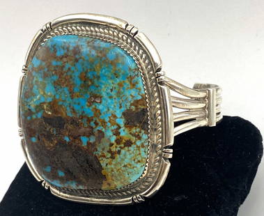 ROYSTON BOULDER TURQUOISE NAVAJO STERLING BRACELET: NATIVE AMERICAN NAVAJO HANDMADE PIECE. GORGEOUS SPIDERWEB MATRIX ON THIS ROYSTON MINE TURQUOISE STONE. SIGNED "EJ STERLING" FOR EDWARD JOHNSON. MARKED TESTED STERLING SILVER. FACE OF BRACELET IS