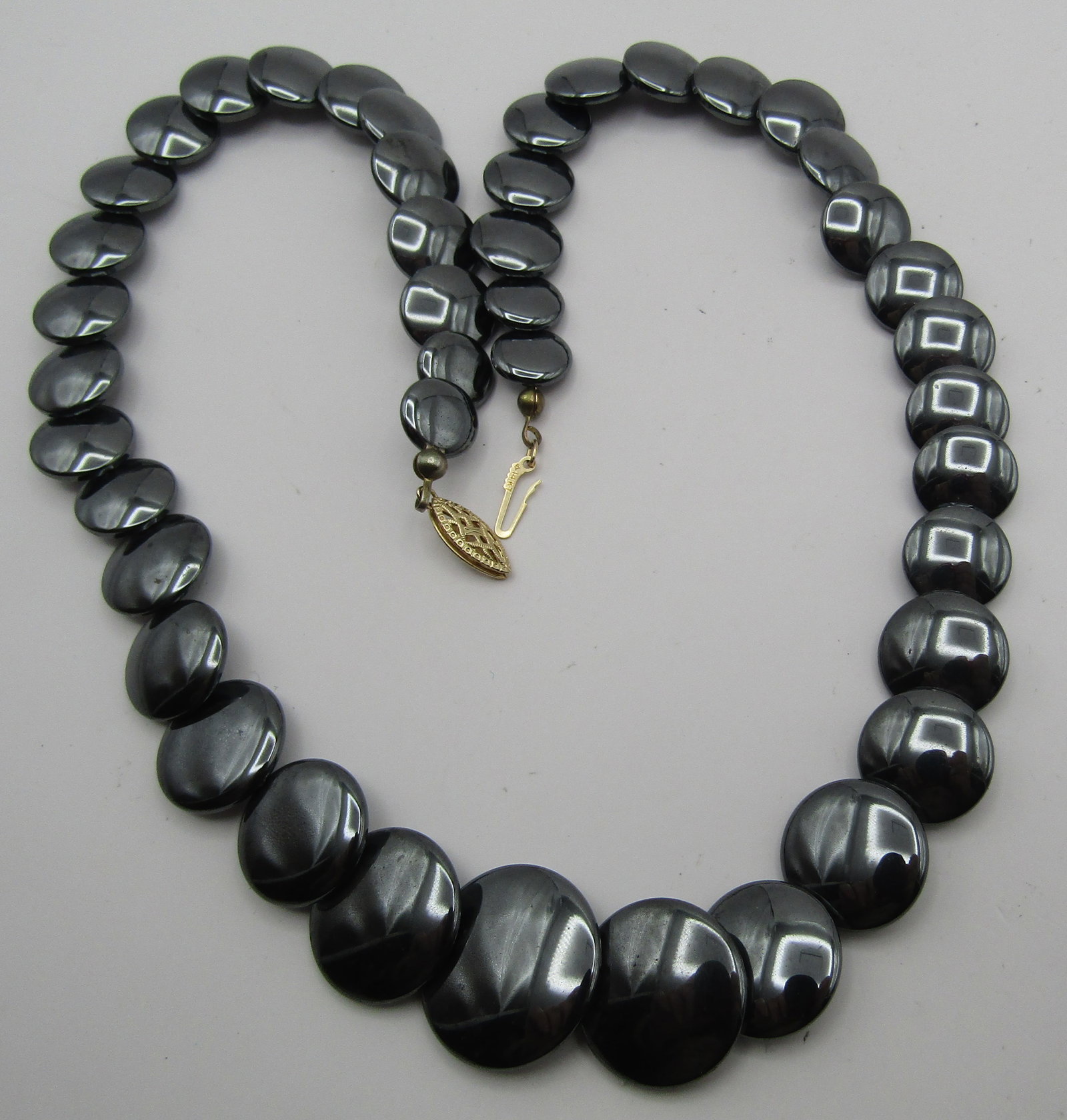 14K GOLD HEMATITE 20MM LENTIL BEAD NECKLACE 19": VINTAGE ESTATE GENUINE HEMATITE LENTIL BEADS UP TO 20MM WIDE; MARKED "14K" YELLOW GOLD. WEIGHS 80.0 GRAMS. MEASURES 19 INCHES LONG. EXCELLENT USED CONDITION. USA SHIPPING $5. NO NTERNATIONAL SHIPPING.