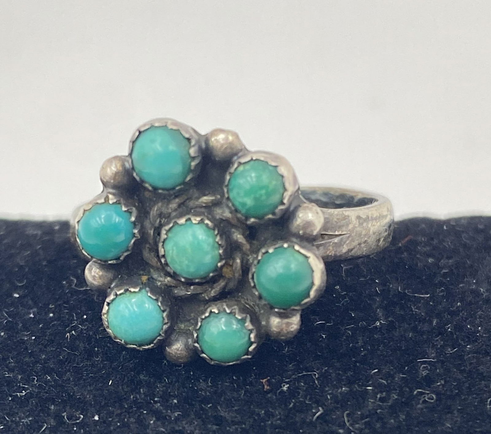 ZUNI PETIT POINT STERLING TURQUOISE CLUSTER RING: VINTAGE NATIVE AMERICAN HANDMADE SNAKE EYE RING. UNSIGNED UNMARKED TESTED STERLING SILVER. WEIGHS 3.2 GRAMS. RING SIZE 7. CLUSTER IS 1/2". USA SHIPPING $5.