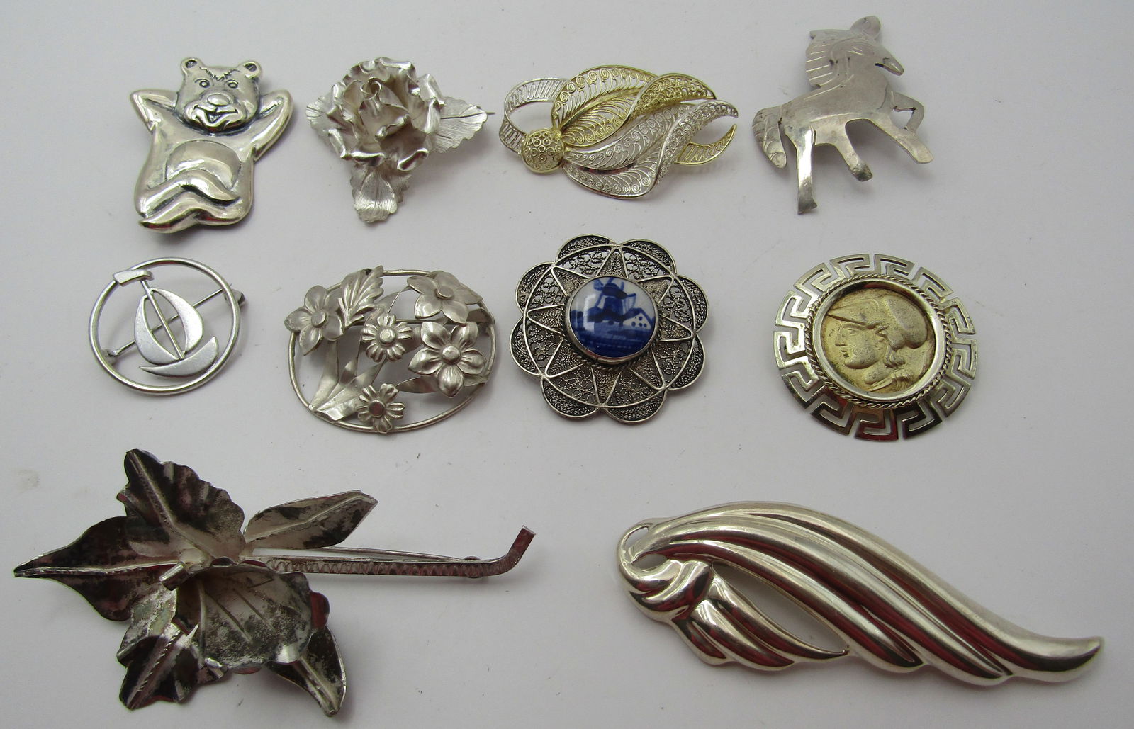 10 PINS STERLING SILVER 87GRAMS COLLECTION LOT: COLLECTION OF TEN VINTAGE ESTATE BROOCHES, ALL MARKED OR TESTED GENUINE SILVER. WEIGHING 87.3 GRAMS. SOME MARKS: CORO, WRE, GERMANY, MEXICO. USA SHIPPING $5. NO INTERNATIONAL SHIPPING.
