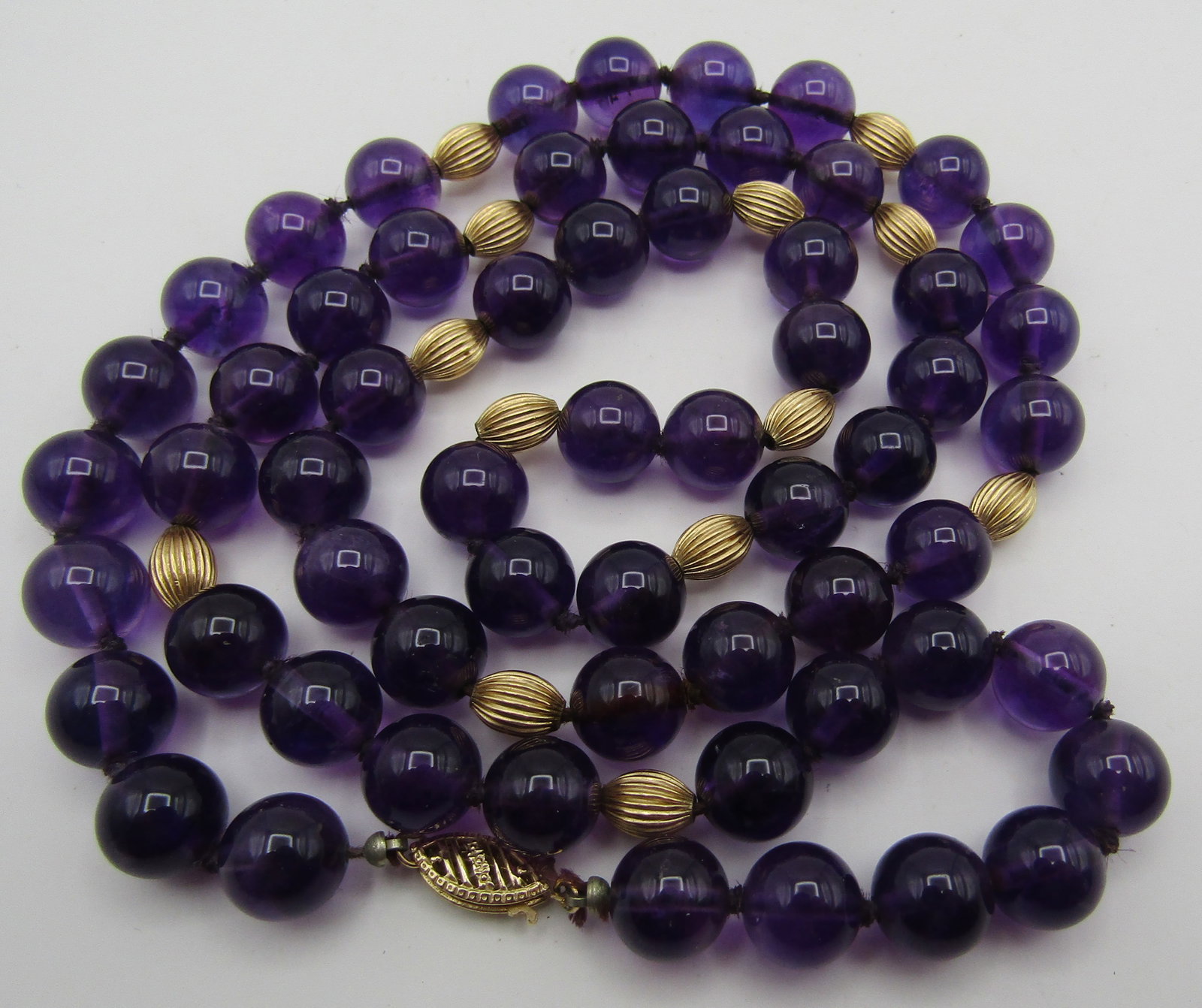 9MM AMETHYST & 14K GOLD BEAD 28" NECKLACE STRAND: VINTAGE ESTATE 14K GOLD & 9MM AMETHYST BEADS. MEASURES 28 INCHES LONG. WEIGHS 61.0 GRAMS. EXCELLENT USED CONDITION. USA SHIPPING $5. NO INTERNATIONAL SHIPPING.