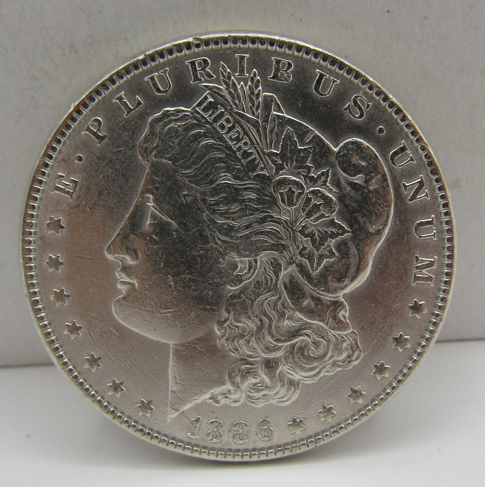 1886  U.S. MORGAN SILVER DOLLAR COIN (1 of 2)