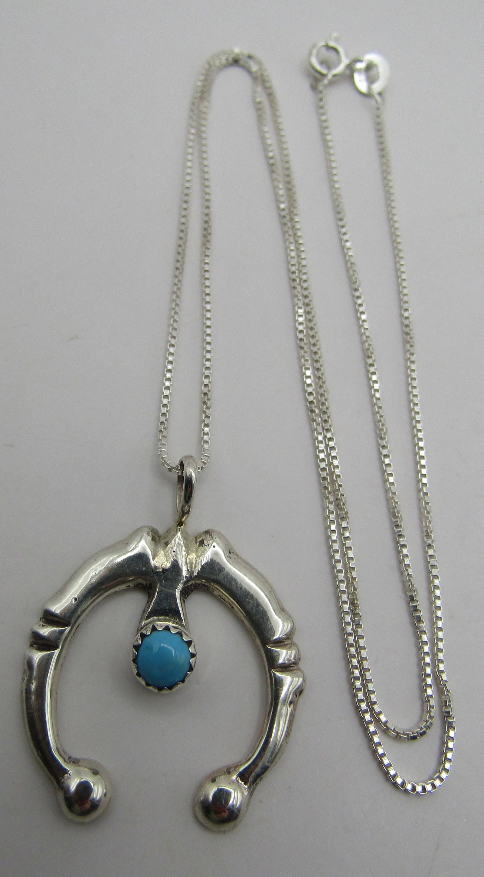 P NELSON TURQUOISE NAJA NECKLACE STERLING SILVER: ARTIST HALLMARKED "N STERLING" PAULINE NELSON. NATIVE AMERICAN SOUTHWEST NAVAJO INDIAN JEWELRY. TURQUOISE CHARM WITH LINK CHAIN MEASURES 18 INCHES LONG, PLUS STERLING 1.25" PENDANT. WEIGHS 6.3 GRAMS. 