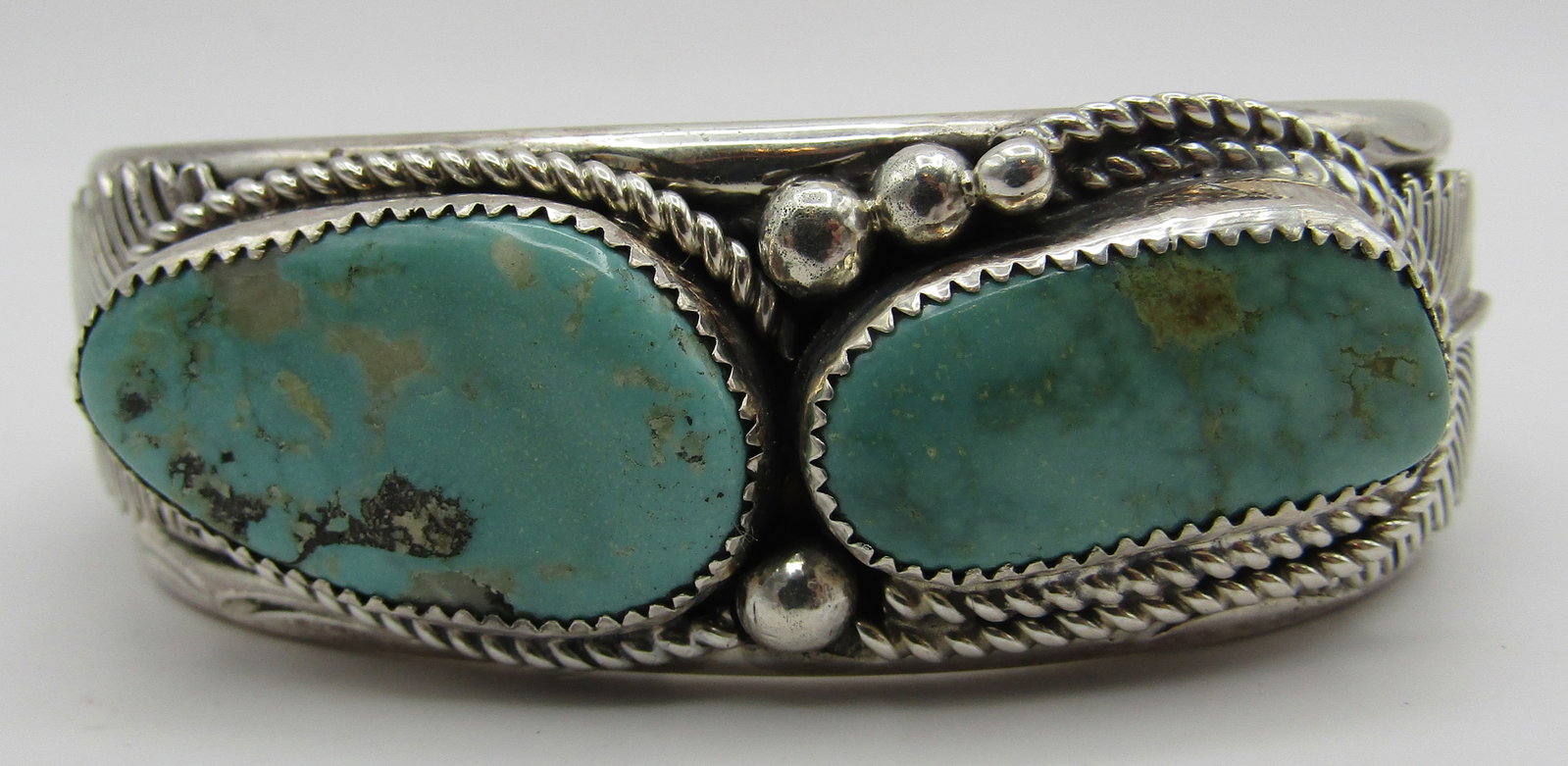 LIVINGSTON TURQUOISE CUFF BRACELET STERLING SILVER: ARTIST HALLMARKED "J STERLING" JASON LIVINGSTON. HANDMADE NATIVE AMERICAN SOUTHWEST NAVAJO INDIAN JEWELRY. TOP MEASURES 1 INCH WIDE. WEIGHS 90.7 GRAMS. FITS AN 8.5 INCH WRIST WITH A 39MM GAP. EXCELLEN