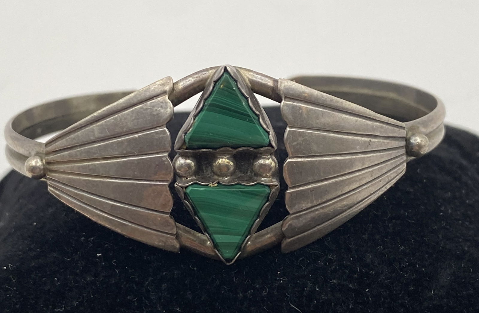 STERLING NAVAJO MALACHITE TRIANGLE BRACELET: UNIQUE NATIVE AMERICAN HANDMADE BRACELET. SIGNED MARKED EAGLE TRADING TESTED STERLING SILVER. WEIGHS 13 GRAMS. FACE IS 7/8" ACROSS. GAP IS 1.75" FLEXIBLE AND FITS 7.25" WRIST TOTAL. USA SHIPPING $5.