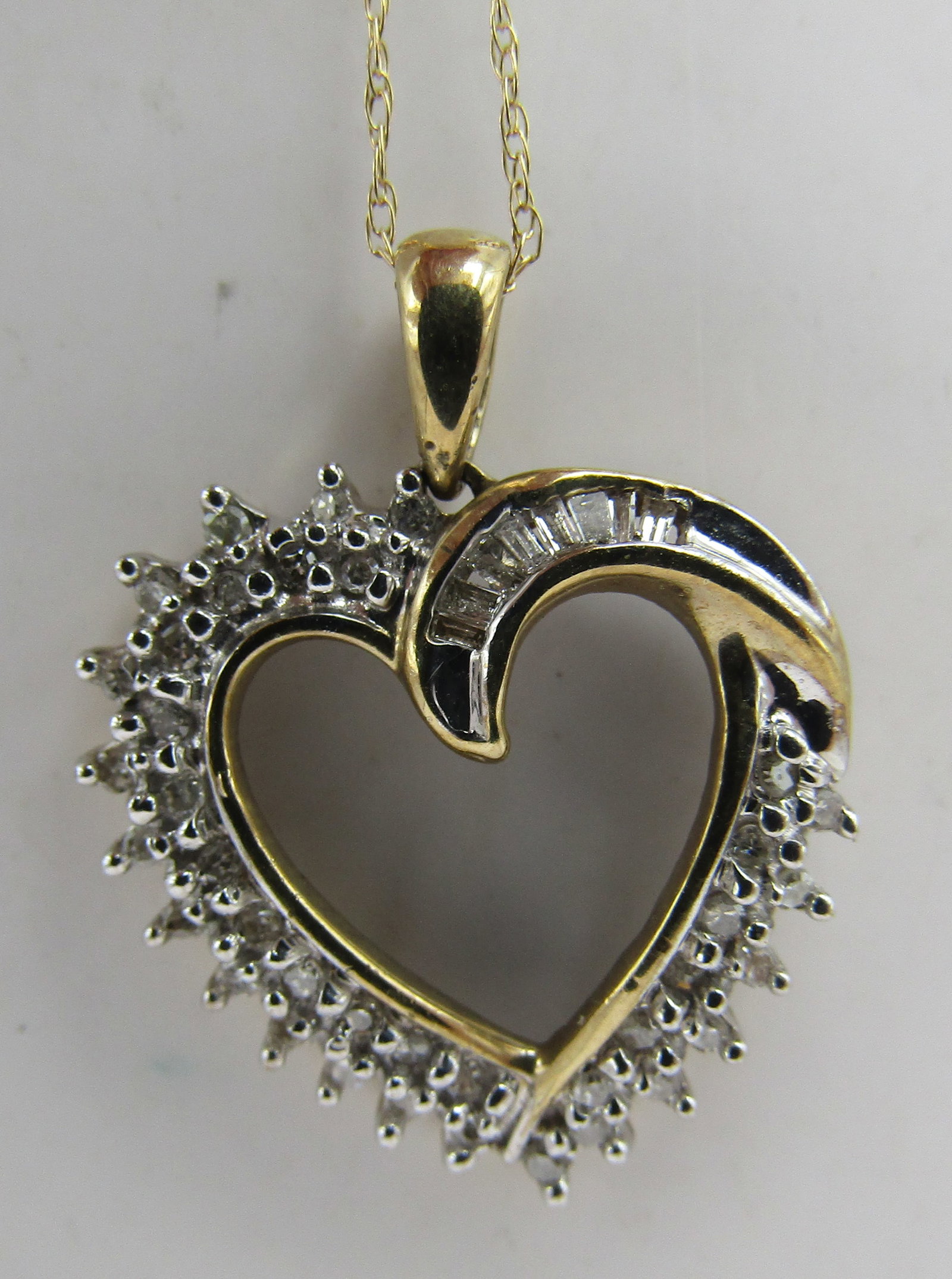 .50CT DIAMOND HEART NECKLACE 10K GOLD WHITE YELLOW: GENUINE MARKED "10K" WHITE & YELLOW GOLD HEART WITH 44 ROUND & BAGUETTE NATURAL DIAMONDS. MEASURES 18 INCHES LONG PLUS 1" BY 3/4" PENDANT. WEIGHS 2.3 GRAMS. EXCELLENT CONDITION. USA SHIPPING $5.