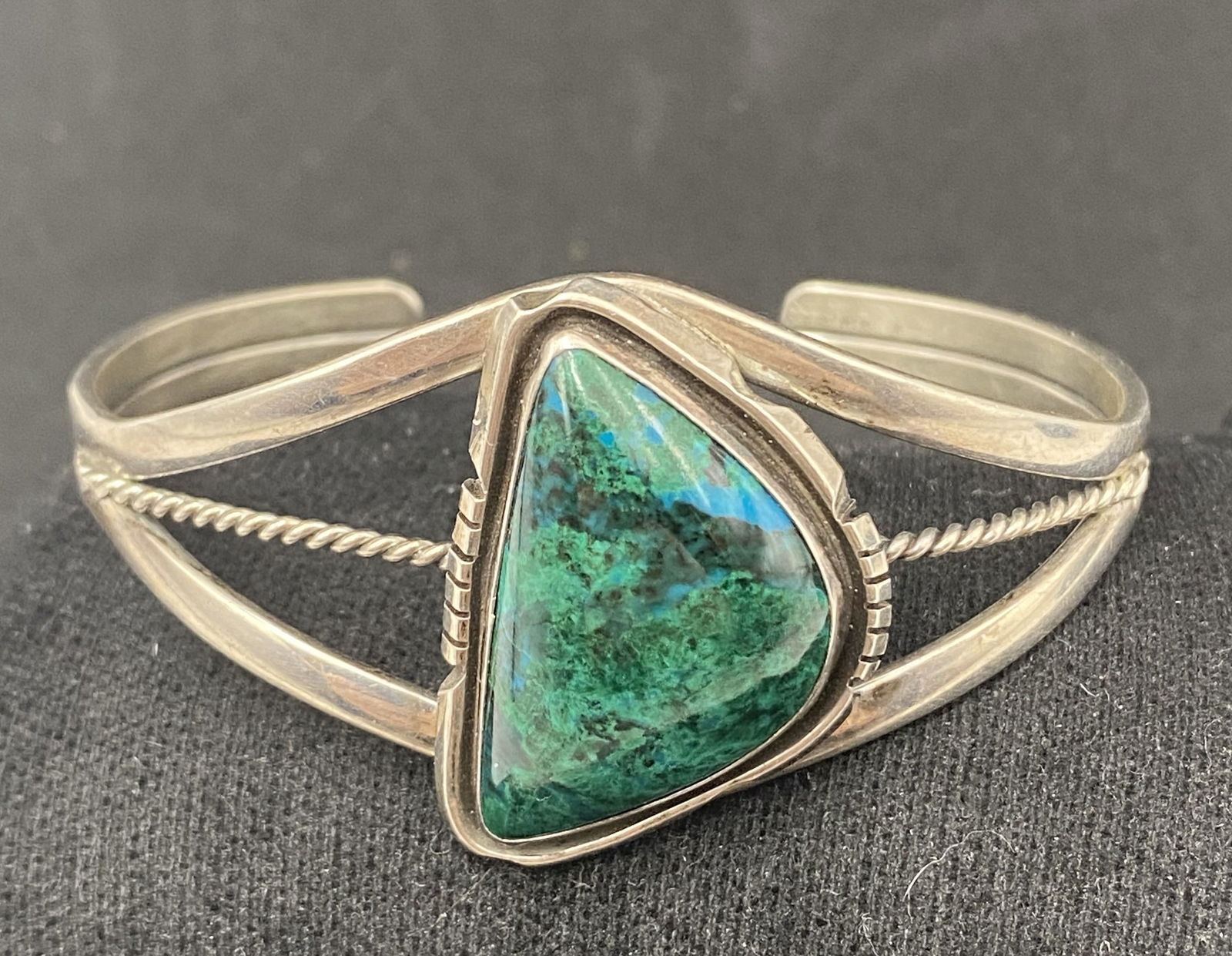 "G N-SW" STERLING MALACHITE NAVAJO BRACELET: NATIVE AMERICAN NAVAJO HANDMADE CUFF BRACELET. SIGNED "GNSW" MALACHITE AZURITE STONE. MARKED TESTED STERLING SILVER. FACE OF BRACELET IS 1.25" ACROSS. GAP IS 1.25" FLEXIBLE AND FITS 6.5" WRIST TOTAL.