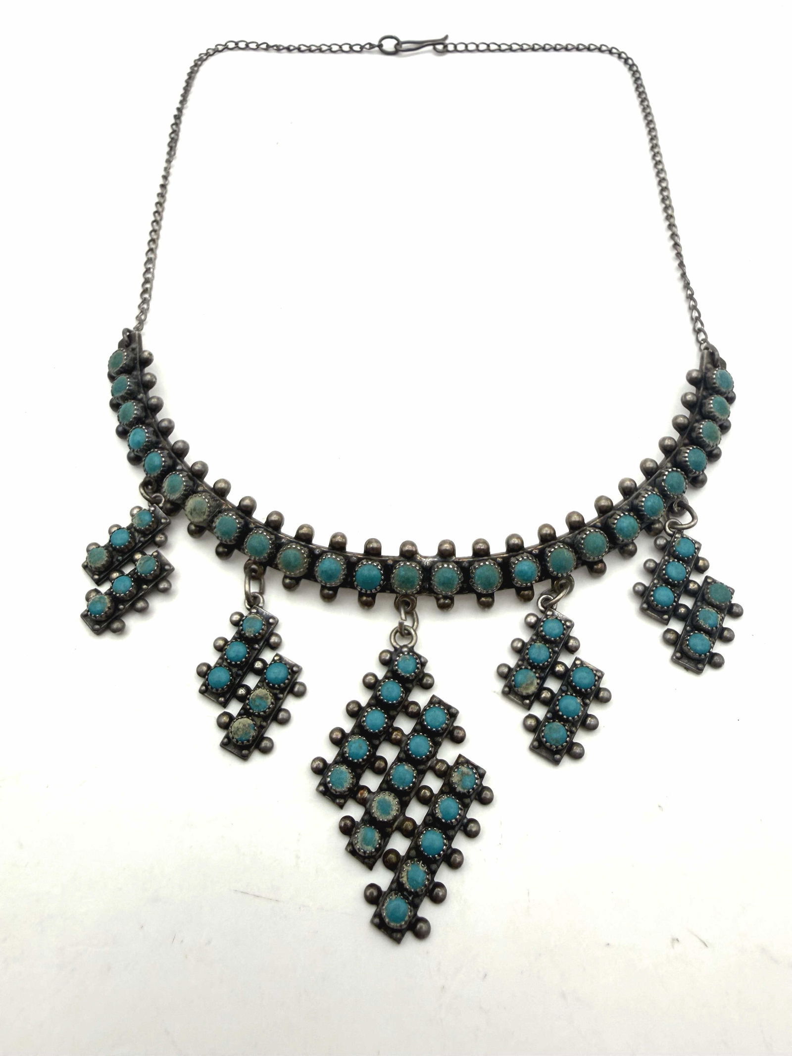 1950S FRED HARVEY TURQUOISE STERLING NECKLACE: VINTAGE NATIVE AMERICAN HANDMADE PETIT POINT SNAKE EYE TURQUOISE NECKLACE. GORGEOUS UNIQUE DEGISN. MARKED "STERLING" TESTED STERLING SILVER. CHOKER NECKLACE IS 15" WITH CURVATURE. CENTER SECTION IS 4"