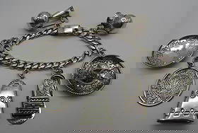 CASTELAN TAXCO 7 CHARM BRACELET STERLING SILVER: 7 JUMBO CHARMS ON A SOLID LINK CHAIN MARKED "CASTELAN, STERLING 925, HECHO EN MEXICO". MEASURES 7 INCHES. WEIGHS 70.0 GRAMS STERLING SILVER. EXCELLENT USED CONDITION. USA SHIPPING $5.