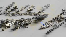 15 CHARM BRACELET STERLING SILVER CIRCA 1940: 15 CHARMS ON A LINK CHAIN MARKED "1941". MEASURES 7 INCHES. WEIGHS 26.6 GRAMS STERLING SILVER. EXCELLENT USED CONDITION. USA SHIPPING $5.