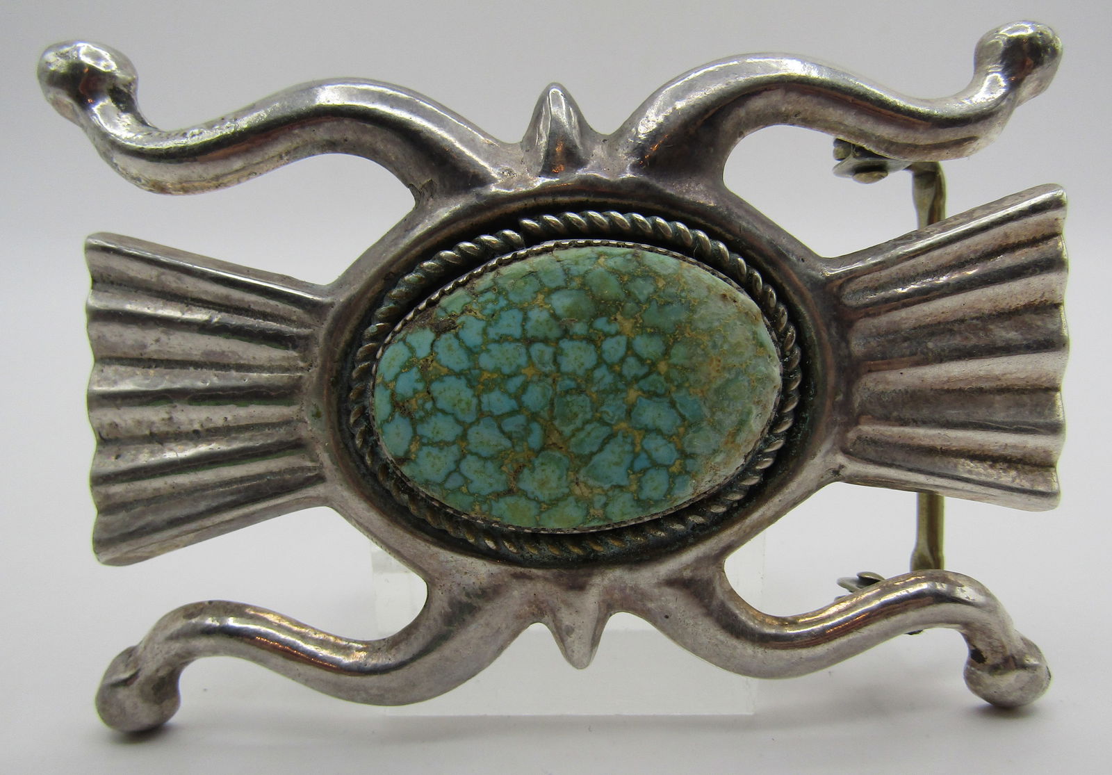 KW" WATERWEB TURQUOISE BELT BUCKLE STERLING SILVER: MUSEUM QUALITY SUPERIOR NATURAL UNTREATED WATERWEB TURQUOISE IN A TUFA CAST BUCKLE. VINTAGE ESTATE ARTIST HALLMARKED "KW STERLING" BUCKLE MEASURES 3.5 INCHES BY 2.5 INCHES AND WEIGHS 78.4 GRAMS. WILL
