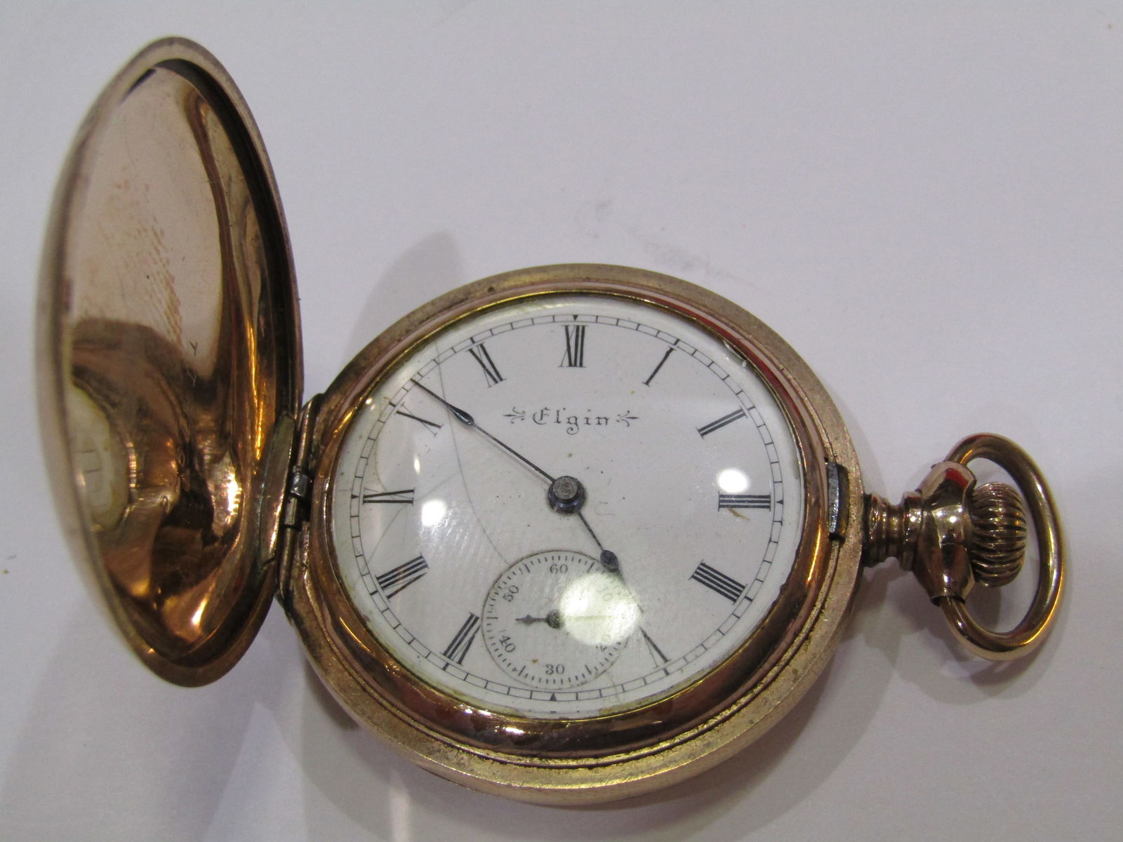 1898 ELGIN NATIONAL POCKETWATCH: 1898 ANTIQUE 14K GOLD FILLED HUNTING CASE POCKETWATCH. 7 JEWEL RUNNING NOT SERVICED. 0 SIZE 1 1/2 INCH ACROSS. HAS CRAZED DIAL. WITH IMPERIAL AUCTION THE COST FOR PACKING AND SHIPPING VIA USPS IN THE