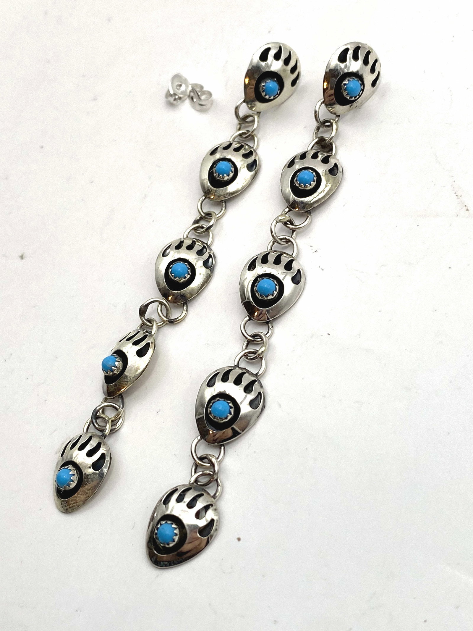 3.75" STERLING NAVAJO BEARPAW TURQUOISE EARRINGS: NEW OLD STOCK NATIVE AMERICAN HANDMADE SHADOWBOY BEAR PAW EARRINGS. MEASURES 3.75". UNSIGNED UNMARKED TESTED STERLING SILVER. WEIGHS 6.7 GRAMS. WITH IMPERIAL AUCTION THE COST FOR PACKING AND SHIPPING