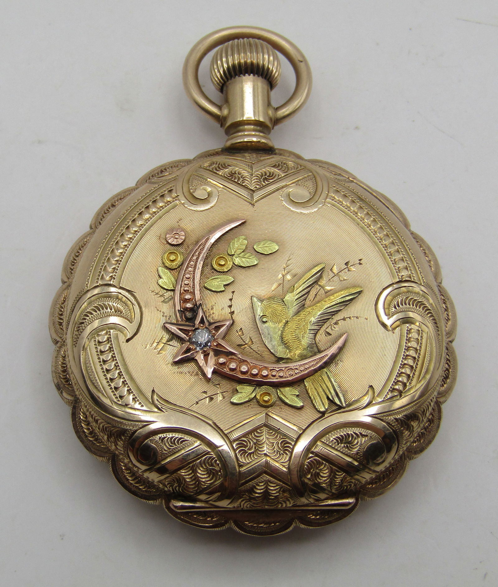 14K GOLD WALTHAM POCKETWATCH RARE MULTICOLOR 1892: RARE SCALLOPED 14K GOLD CASE MULTI COLOR 1892 AMERICAN WALTHAM HUNTING CASE POCKET WATCH WITH BIRDS, FLOWERS, MOON AND STAR DIAMOND. ALL 14K GOLD. SIZE 6. 15 JEWEL MOVEMENT. 1 3/4 INCH CASE. WEIGHS 55