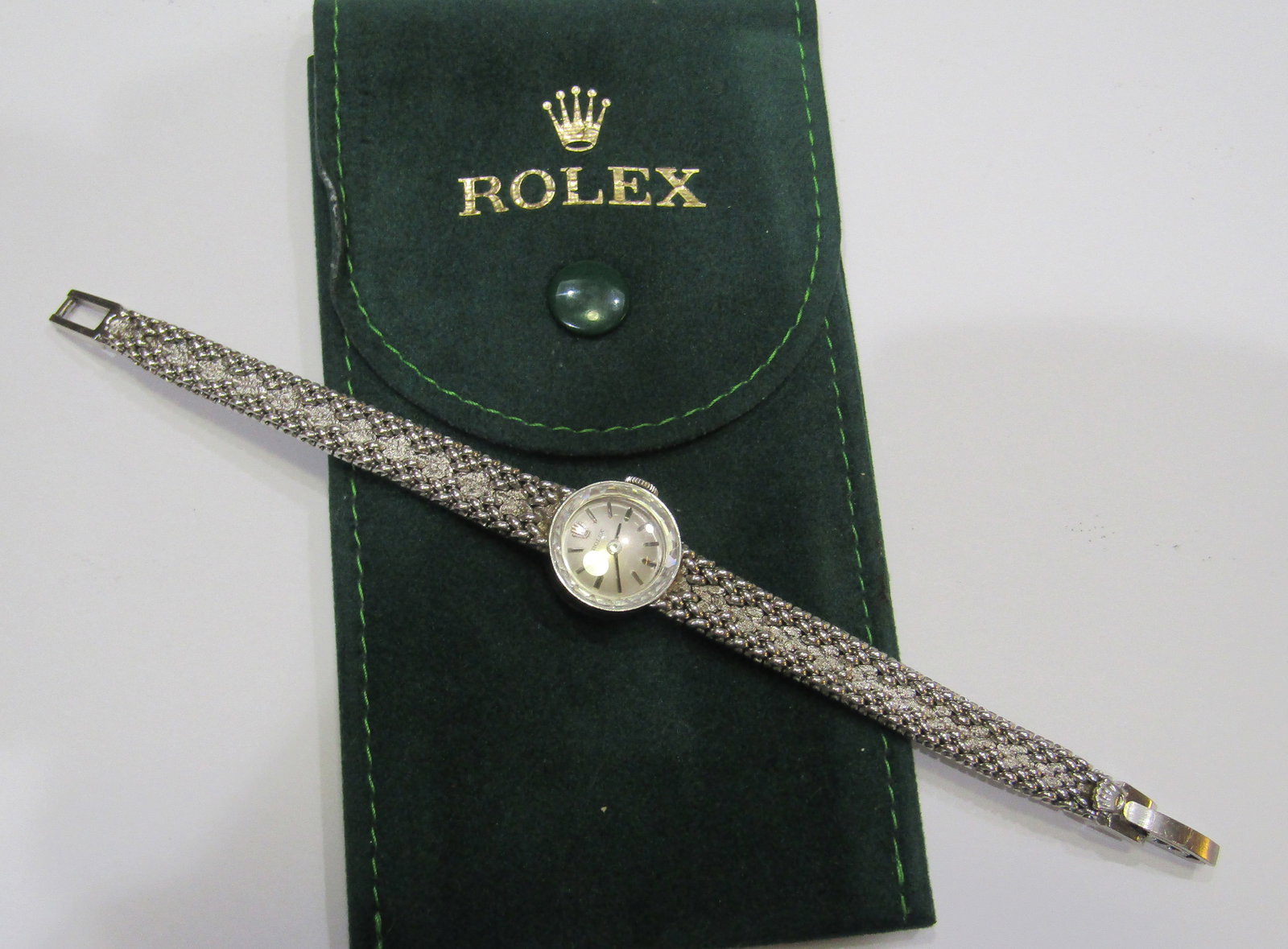 14K GOLD ROLEX WATCH LADIES: 14K WHITE GOLD GENUINE ROLEX WATCH. 17 JEWEL CAL 1400 MOVEMENT. 5/8 INCH WIDE AND 6 INCH LONG. WEIGHS 19.8 GRAMS. GOOD RUNNING CONDITION. WITH IMPERIAL AUCTION THE COST FOR PACKING AND SHIPPING VIA US