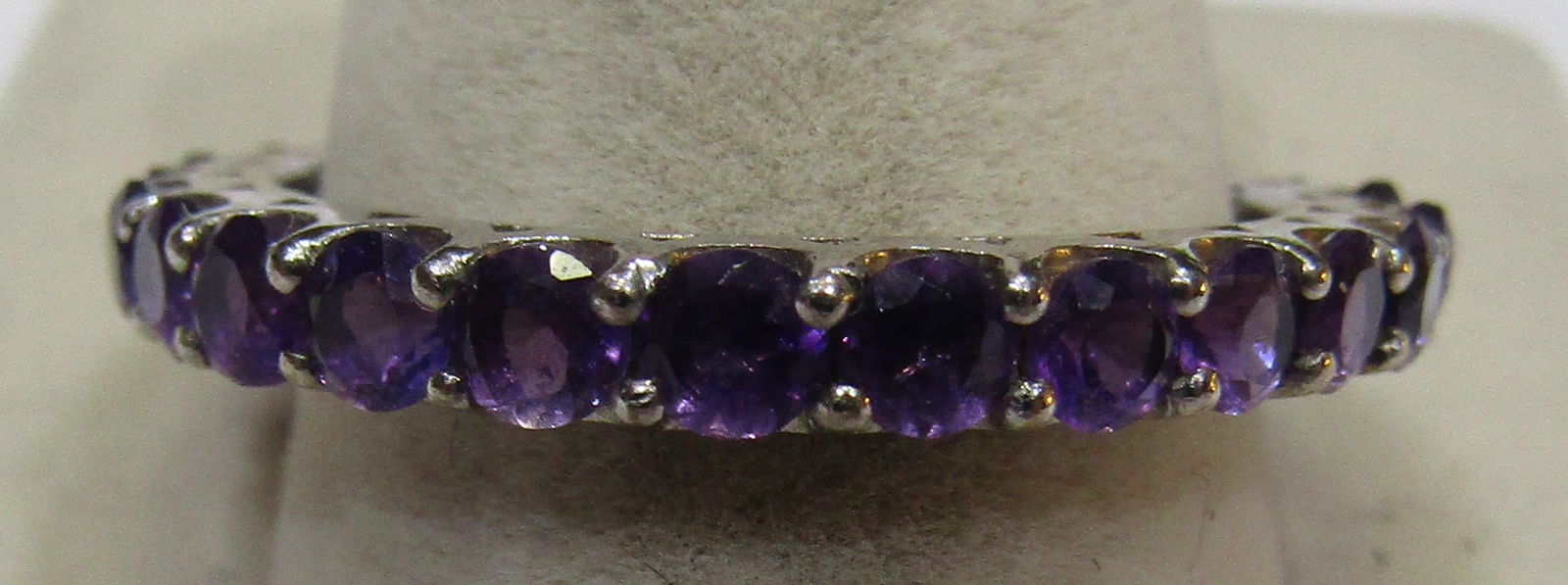 AMETHYST ETERNITY BAND RING STERLING SILVER SIZE10: GENUINE AMETHYST ETERNITY BAND RING SIZE 10. GEMSTONES IN STERLING SILVER MARKED 925. WEIGH 2.9 GRAMS. VINTAGE ESTATE EXCELLENT CONDITION. WITH IMPERIAL AUCTION THE COST FOR PACKING AND SHIPPING VIA U