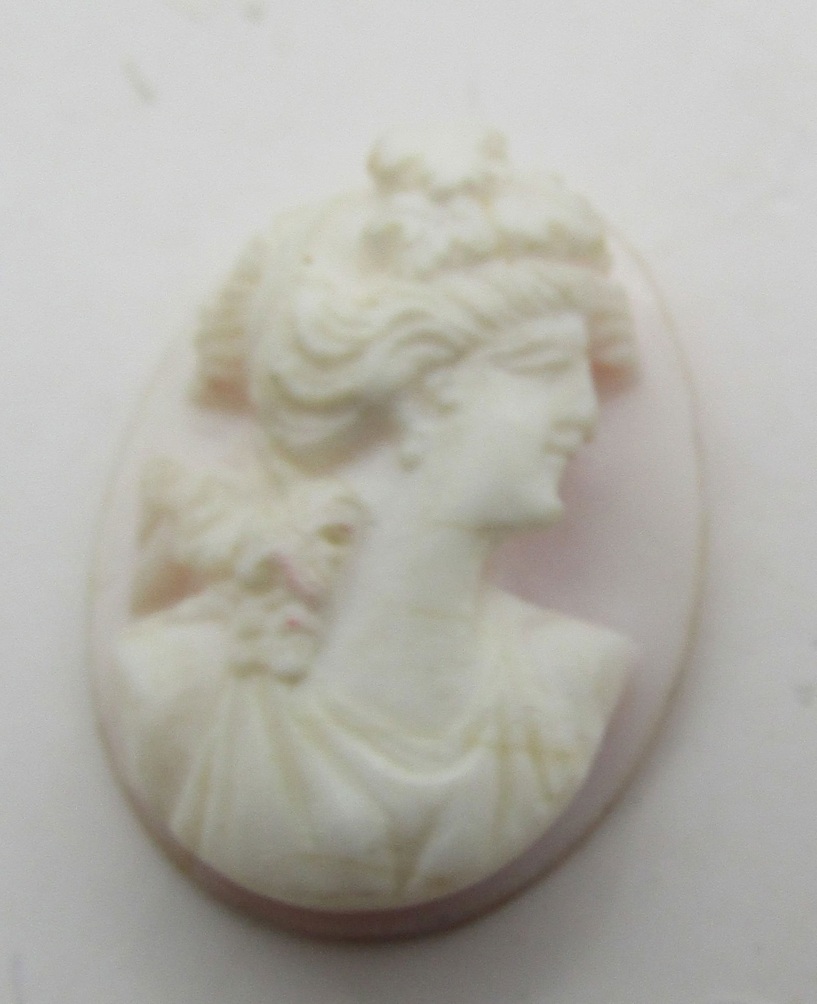 ANGEL SKIN CARVED SHELL CAMEO: 24mm by 18mm PINK CARVED SHELL CAMEO. EXCELLENT USED CONDITION. WITH IMPERIAL AUCTION THE COST FOR PACKING AND SHIPPING VIA USPS IN THE USA IS $5.