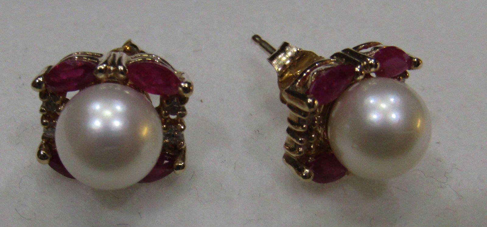 MIKIMOTO RUBY DIAMOND PEARL EARRINGS 14K GOLD: VINTAGE ESTATE 7MM AKOYA PEARL, 8 RUBY AND 8 DIAMOND EARRINGS. MARKED "M 14K" YELLOW GOLD. MEASURE 9MM BY 10MM. WEIGH 4.0 GRAMS. EXCELLENT USED CONDITION. WITH IMPERIAL AUCTION THE COST FOR
