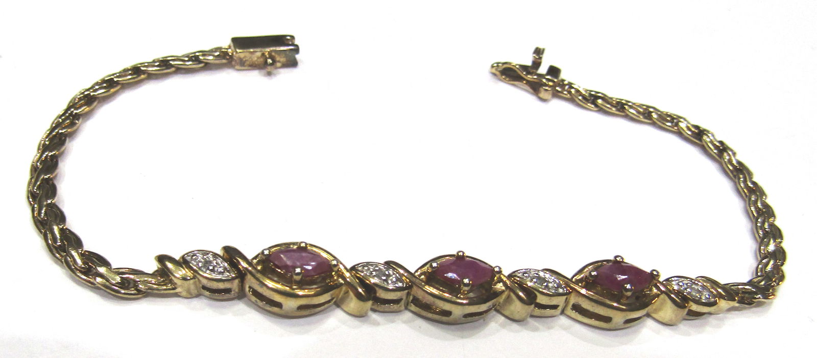 RUBY DIAMOND BRACELET GOLD ON STERLING SILVER: GENUINE .50 CARAT TOTAL WEIGHT; VINTAGE ESTATE 3 RUBIES WITH 5 DIAMOND MOUNTED IN GOLD ON STERLING SILVER. MEASURES 7 INCHES LONG. WEIGHS 9.9 GRAMS. EXCELLENT USED CONDITION. WITH IMPERIAL