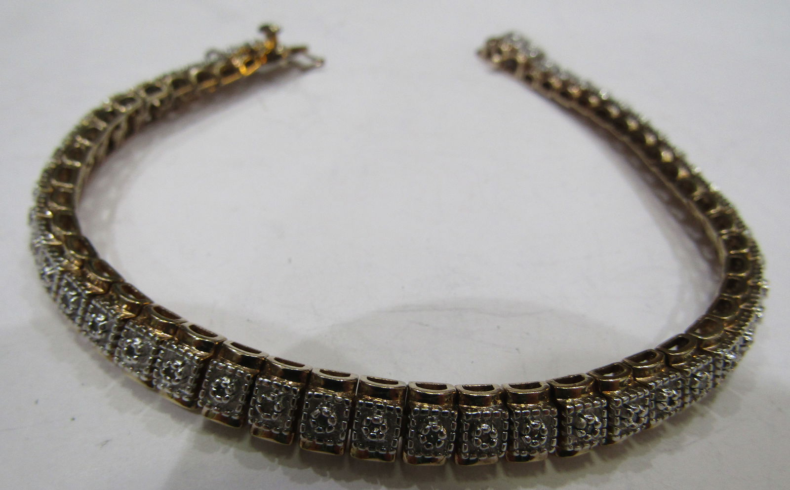 48 DIAMOND BRACELET GOLD ON STERLING SILVER: VINTAGE ESTATE BRACELET WITH 48 GENUINE DIAMONDS MOUNTED IN GOLD ON STERLING SILVER. MEASURES 7.5 INCHES LONG. WEIGHS 20.0 GRAMS. EXCELLENT USED CONDITION. WITH IMPERIAL AUCTION THE COST FOR