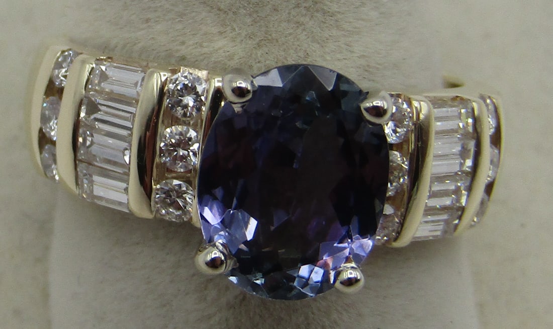 2.4CT NATURAL TANZANITE RING DIAMONDS &14K GOLD 7G: 2.40 CARAT OVAL PURPLE BLUE NATURAL TANZANITE. RING SET WITH 1.25 CARATS OF G-VS DIAMONDS. 14K YELLOW GOLD RING SIZE 8 AND WEIGHS 7.2 GRAMS. WITH IMPERIAL AUCTION THE COST FOR PACKING AND SHIPPING VIA