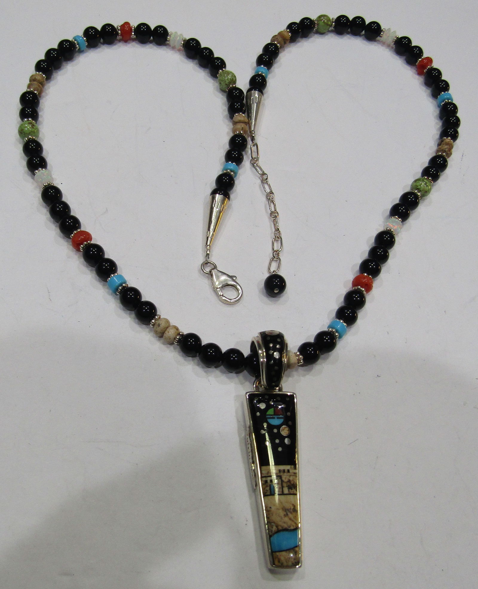 CALVIN BEGAY NIGHTSKY NECKLACE STERLING SILVER: ARTIST SIGNED "CALVIN STERLING" AMAZING INLAID NIGHT SKY; TURQUOISE, JET & AGATE. 24 INCH LONG STRAND OF ASSORTED GEMSTONES;RED CORAL, FIRE OPAL, TURQUOISE, ONYX, AGATE & OTHERS. PLUS A 2 INCH PENDANT