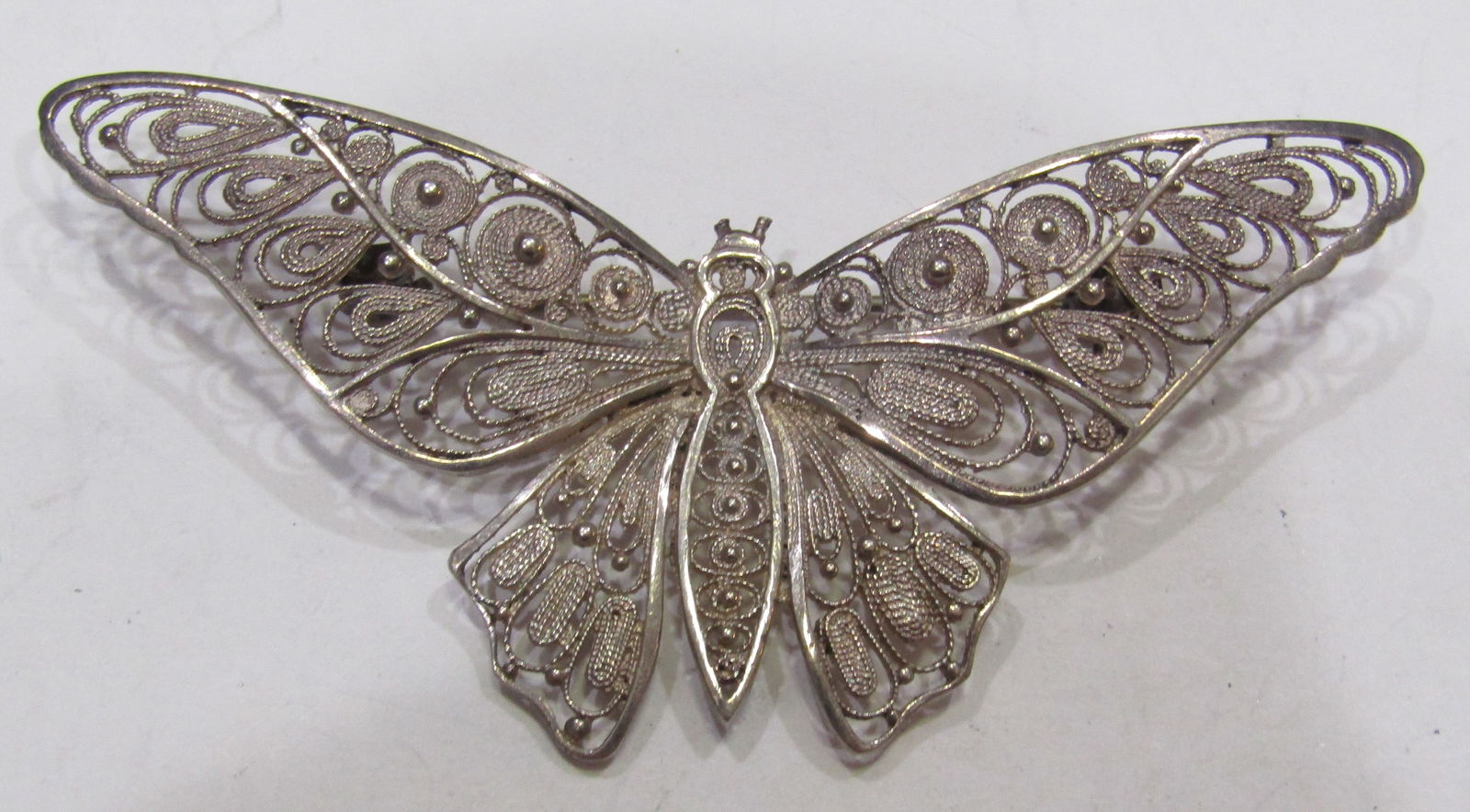 "LM" 835 STERLING SILVER FILIGREE BUTTERFLY PIN: ANTIQUE VINTAGE ESTATE HALLMARKED "835", EUROPEAN SILVER; AND HALLMARK LOOKS LIKE SCRIPT "LM" PIN. MEASURES 3 INCHES BY 1.5". WEIGHS 7.4GRAMS . EXCELLENT CONDITION. WITH IMPERIAL AUCTION THE COST FOR