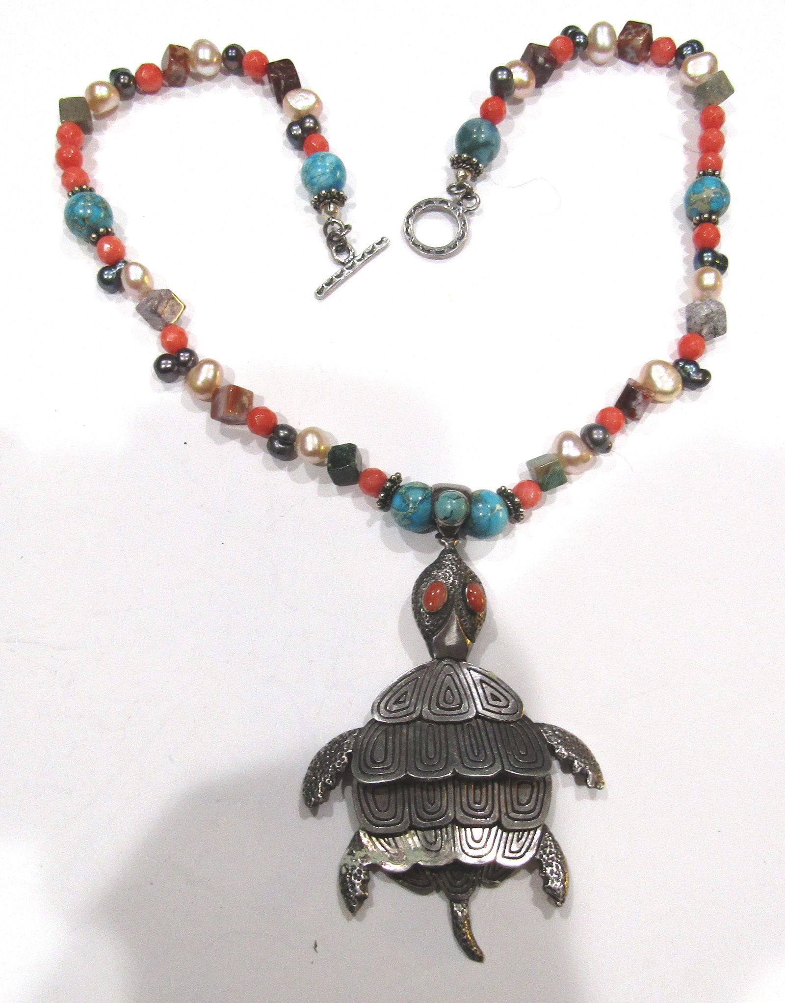 "KZ" MULTI GEMSTONE TURTLE NECKLACE STERLING SILVE: VINTAGE ESTATE MOVEABLE TURTLE NECKLACE WITH ASSORTED SEMI PRECIOUS STONE BEADS; TURQUOISE,FACETED CORAL, PEARLS AND OTHERS. STERLING SILVER TURTLE MARKED "KZ". NECKLACE MEASURE 19 INCHES LONG. PENDAN