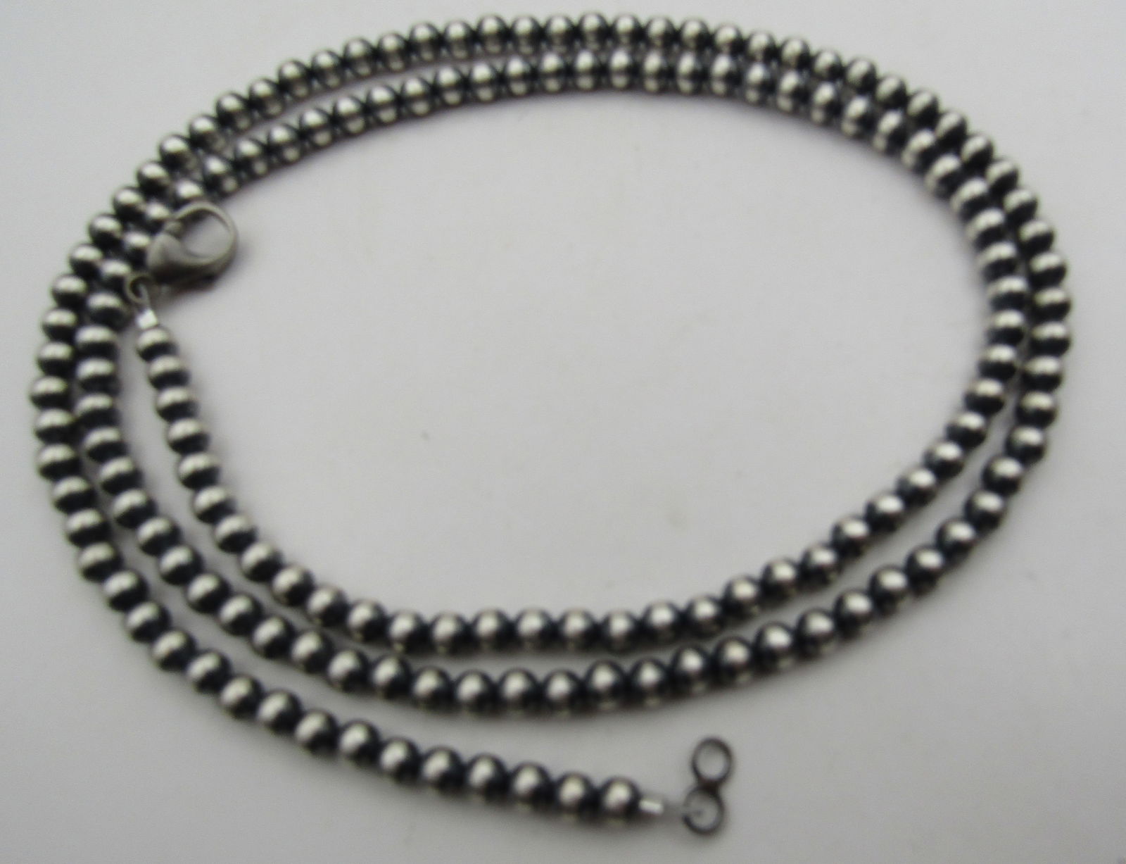 30" NAVAJO PEARL STERLING SILVER BEAD NECKLACE: 5MM BEAD NECKLACE TESTED STERLING SILVER NATIVE AMERICAN SOUTHWEST INDIAN NAVAJO JEWELRY. MEASURES 30 INCHES LONG. WEIGHS 21.2 GRAMS. EXCELLENT CONDITION. WITH IMPERIAL AUCTION THE COST FOR PACKING AN