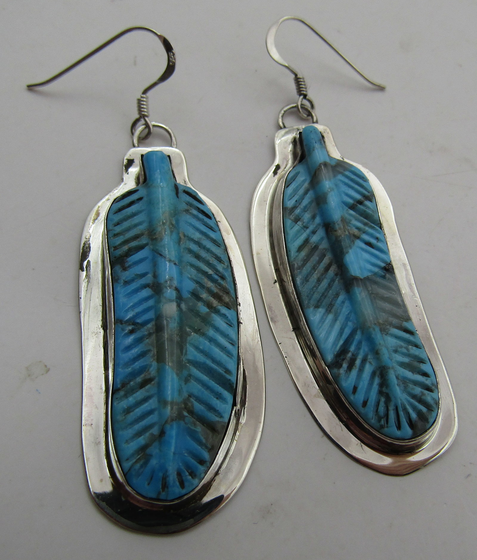 "D" HUGE CARVED TURQUOISE EARRINGS STERLING SILVER: ARTIST HALLMARKED "D STERLING". 2 FABULOUS CARVED TURQUOISE FEATHERS. MEASURE 2.5 INCHES BY 7/8 INCHES. TESTED STERLING SILVER. NATIVE AMERICAN SOUTHWEST NAVAJO INDIAN JEWELRY. WEIGHS 13.0GRAMS. EXCEL