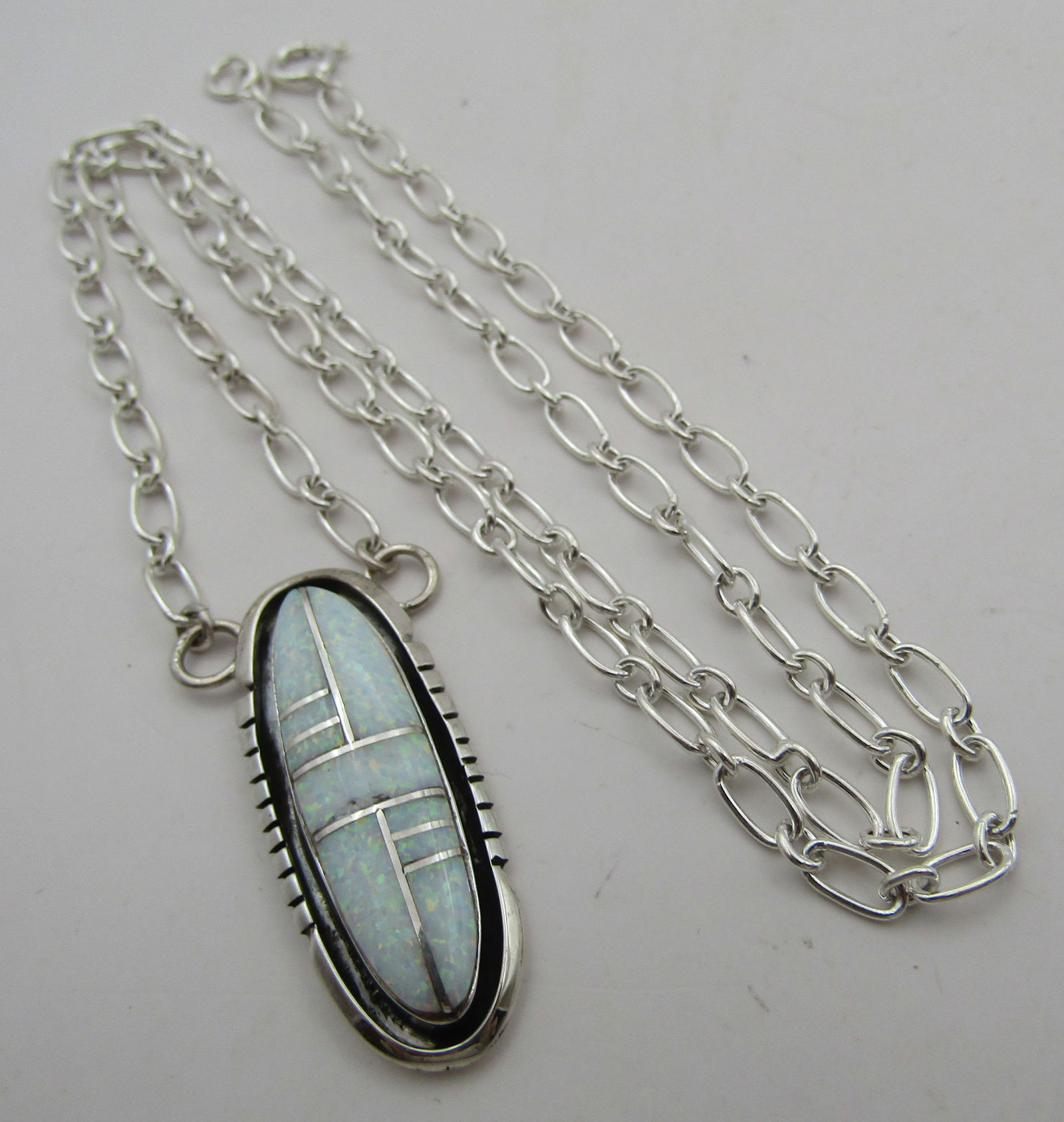 JOHNSON OPAL PENDANT & NECKLACE STERLING SILVER: ARTIST SIGNED "EJ STERLINGI" EDWARD JOHNSON. MEASURES 21 INCHES LONG PLUS A 1.5 INCH CENTER DROP. TESTED STERLING SILVER. NATIVE AMERICAN SOUTHWEST INDIAN JEWELRY. WEIGHS 9.0 GRAMS.