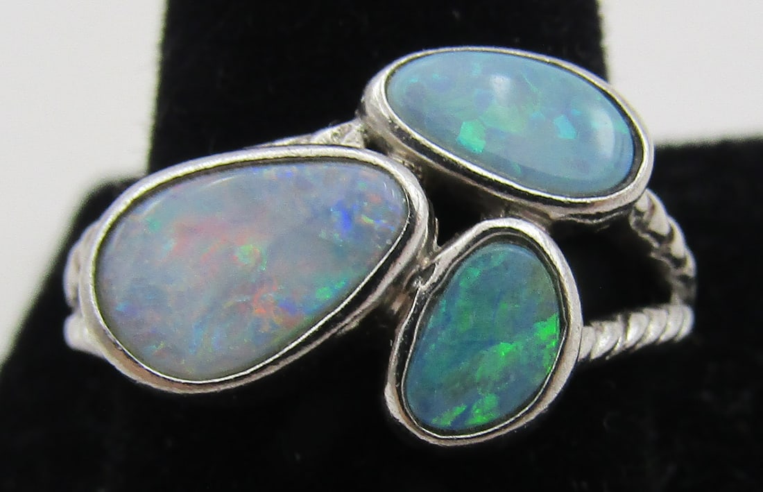 3 BLACK OPAL RING STERLING SILVER SIZE 8: ARTIST SIGNED "AW ZUNI" ADRIAN WALLACE. 3 FABULOUS INLAID VINTAGE ESTATE RING WITH 3 BLACK OPALS. SIZE 8. WEIGHS 3.5.GRAMS. EXCELLENT USED CONDITION. WITH IMPERIAL AUCTION THE COST FOR