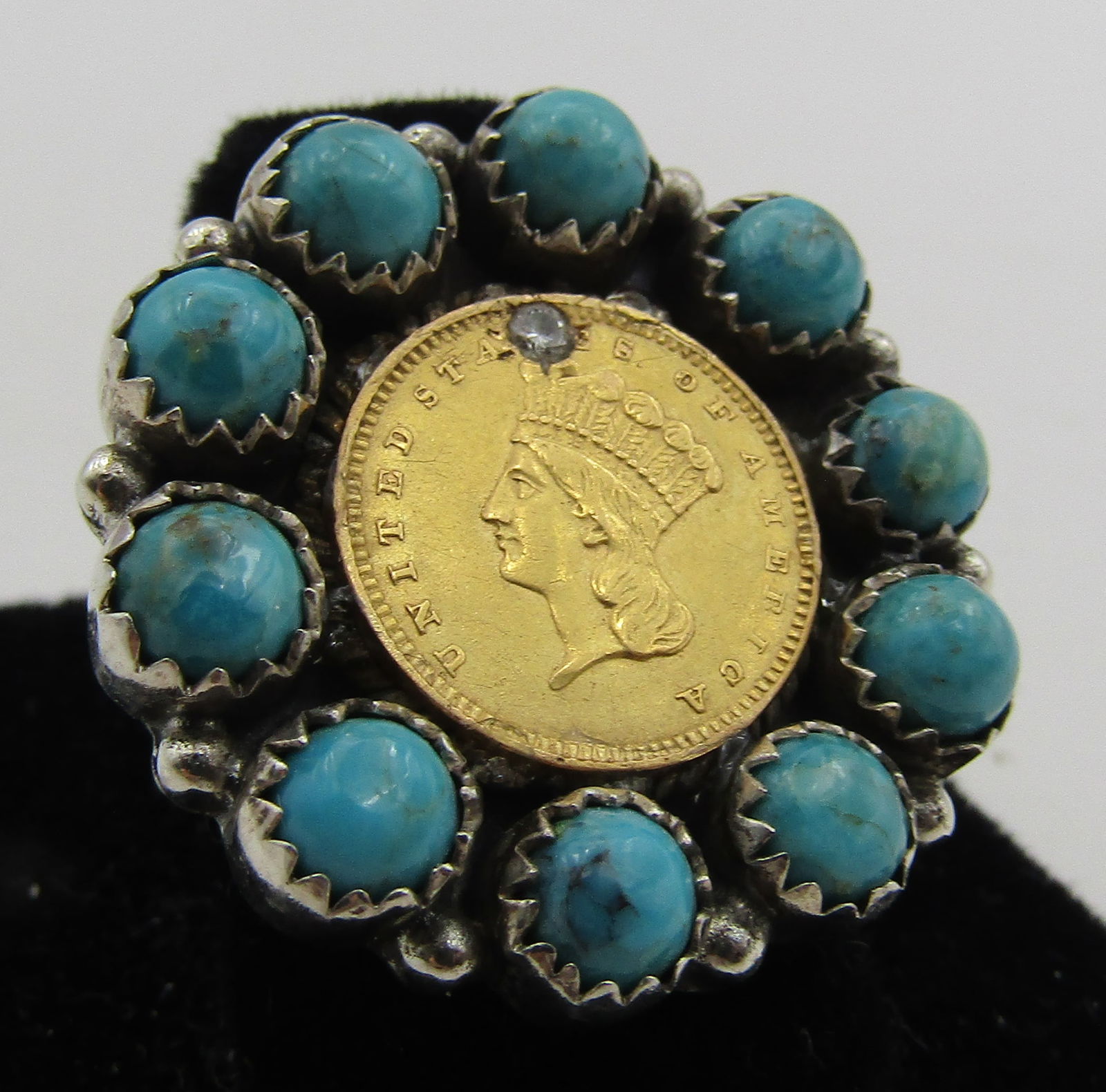 1857 GOLD COIN DIAMOND TURQUOISE RING STERLING: VINTAGE ESTATE RING WITH A US 1857 ONE DOLLAR GOLD COIN, 1 GENUINE DIAMOND AND 10 GENUINE TURQUOISE STONES MOUNTED IN STERLING SILVER. MARKED "HADA STERLING". MEASURES 1 INCH WIDE. SIZE 8. WEIGHS 14.1