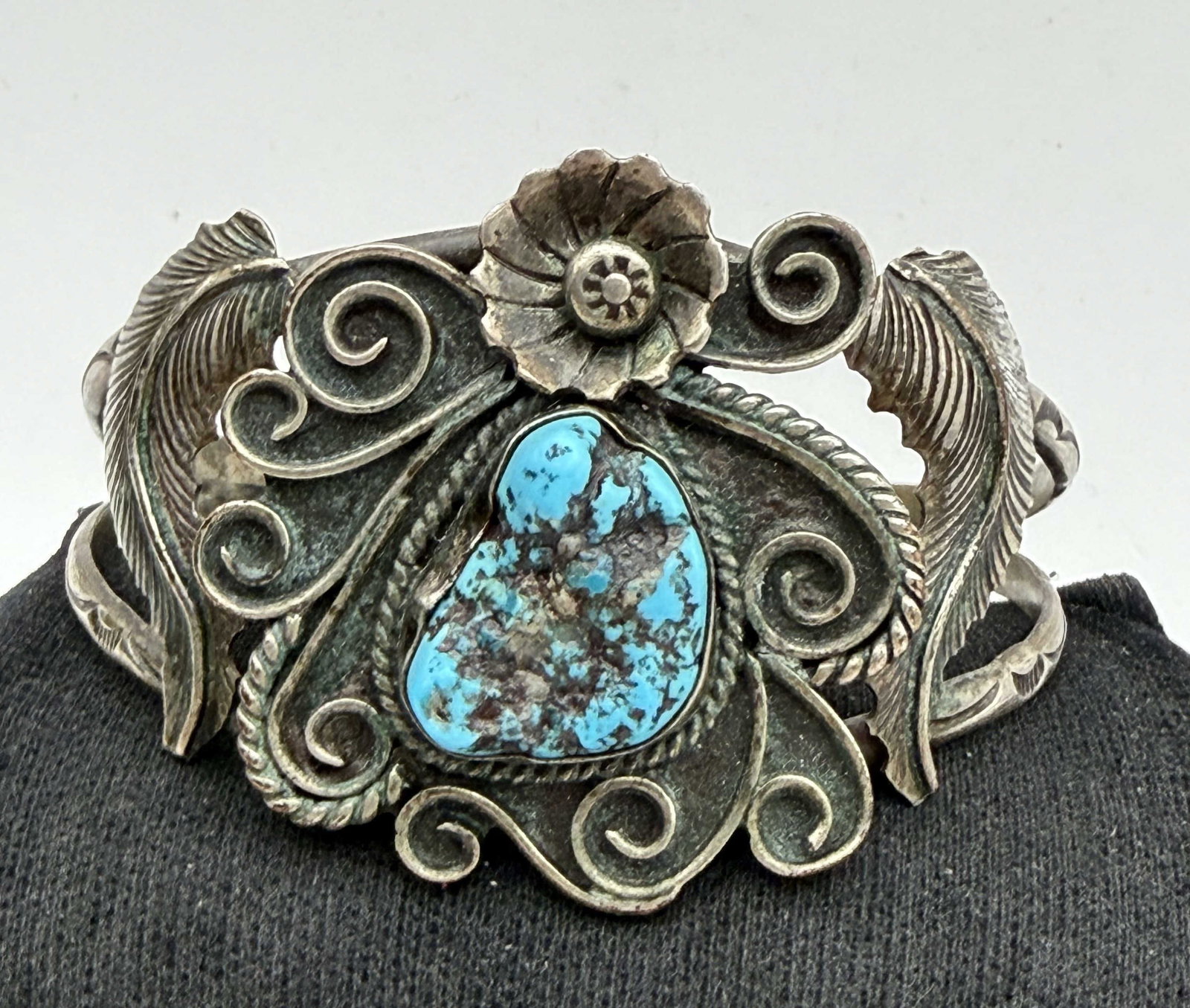 SIGNED OLD PAWN NAVAJO STERLING TURQUOISE BRACELET: VINTAGE NATIVE AMERICAN HANDMADE BRACELET SIGNED "JO". UNIQUE OLD FLORAL DESIGN WITH HAND STAMPED SHANKS. TESTED STERLING SILVER. FITS 6.75" WRIST TOTAL, GAP IS 1.5". WEIGHS 34 GRAMS. WITH IMPERIAL AU