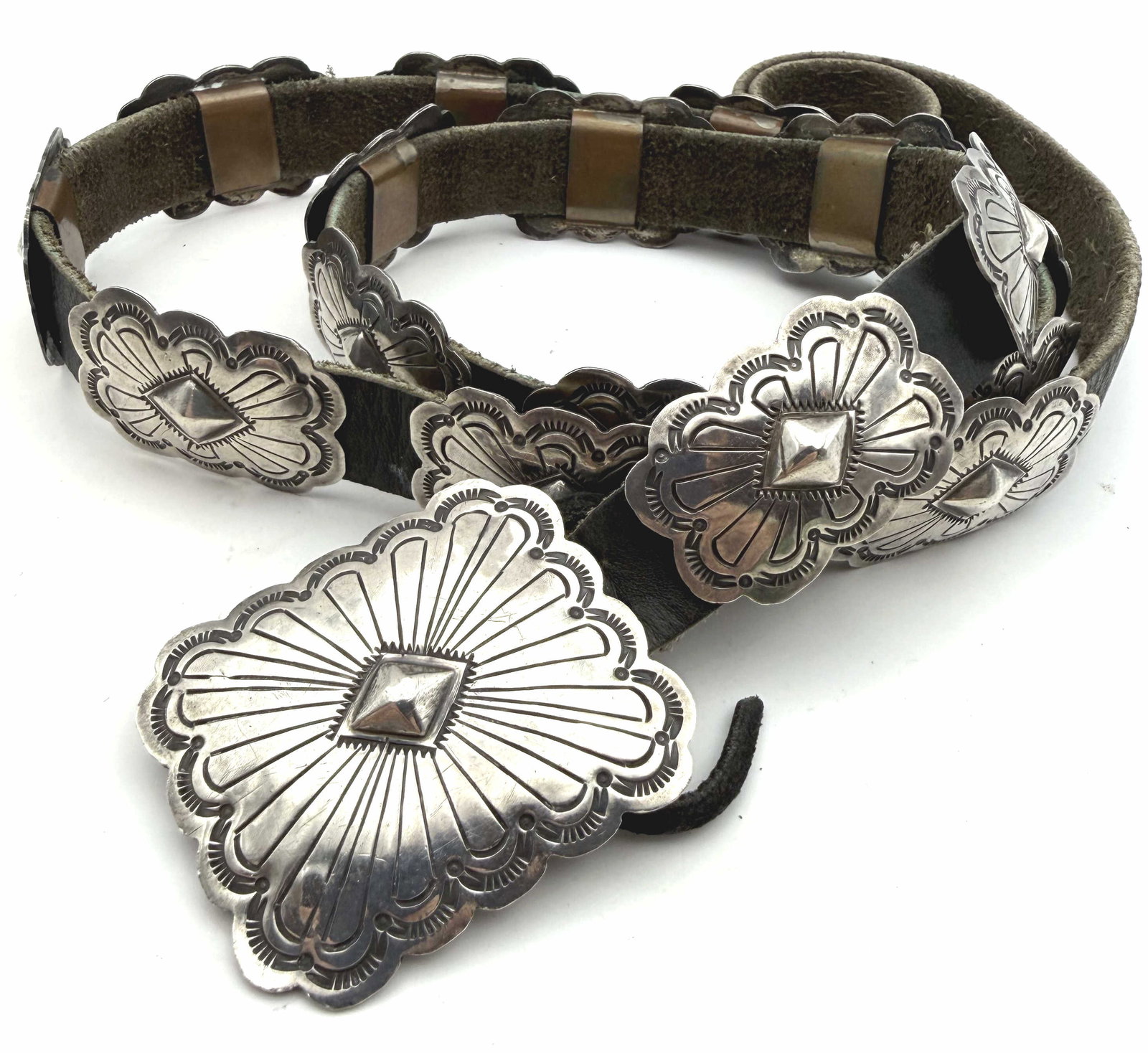 "J" 187 GRAM VINTAGE STERLING NAVAJO CONCHO BELT: VINTAGE NATIVE AMERICAN NAVAJO HANDMADE SOUTHWESTERN RODEO CONCHO BELT. SIGNED "J" MARKED TESTED STERLING SILVER. TOTAL LENGTH IS 42". BUCKLE IS 2" X 1.75". CONCHOS ARE 1.5" X 1". WEIGHS 187 GRAMS TOT