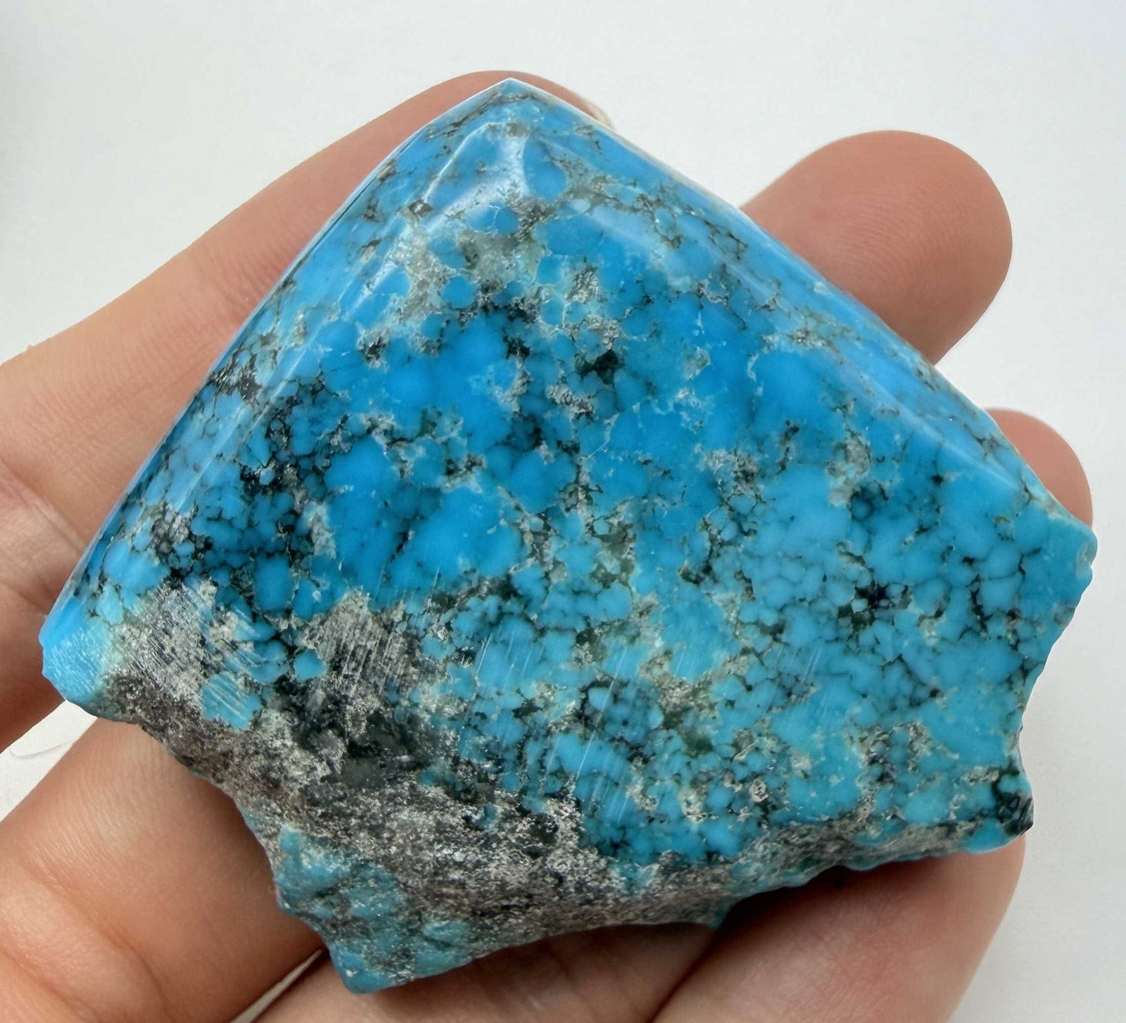 62 GRAM 2" SPIDERWEB TURQUOISE STONE NUGGET: GORGEOUS TURQUOISE SPECIMEN FROM THE KINGMAN MINE. MEASURES 2" X 2" X 0.5". ONE HALF IS POLISHED, THE OTHER SIDE IS ROUGH. WEIGHS 62 GRAMS OR 310 CARATS. WITH IMPERIAL AUCTION THE COST FOR PACKING AND