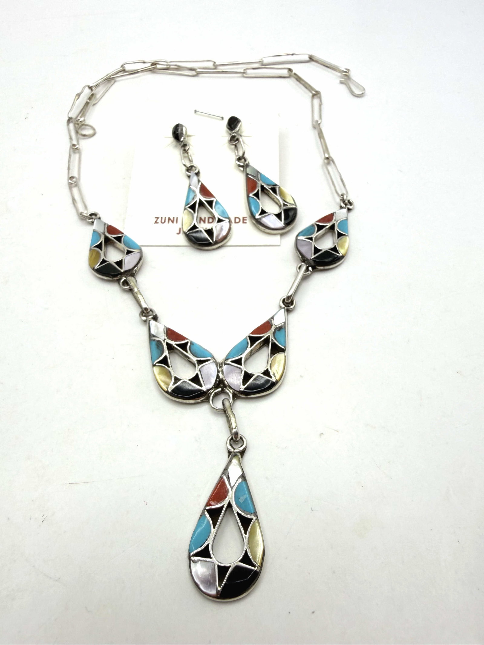 EMMA BOWEKATY ZUNI STERLING TURQUOISE NECKLACE: NEW OLD STOCK MULTICOLOR ZUNI NATIVE AMERICAN INLAID NECKLACE AND EARRINGS MATCHING SET. RED CORAL ONYX TURQUOISE AND SHELL STONES. TESTED STERLING SILVER. EARRINGS ARE 1-5/8" LONG AND NECKLACE IS 20"