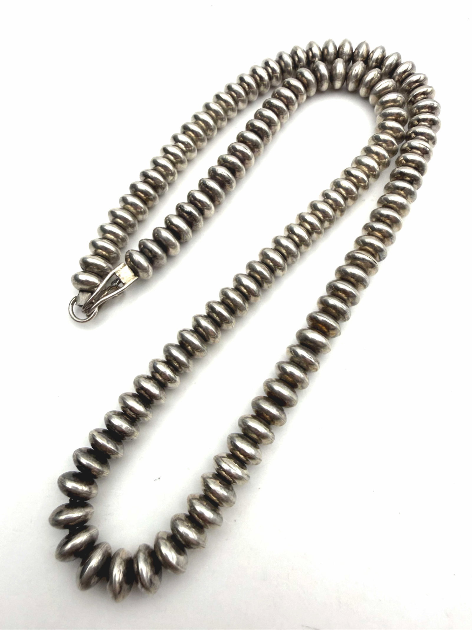 8MM STERLING NAVAJO PEARLS NECKLACE SAUCER BEADS: NATIVE AMERICAN HANDMADE NAVAJO PEARLS (M&M STYLE ROUNDED SAUCER BEADS). TESTED STERLING SILVER. WEIGHS 52.5 GRAMS TOTAL. 20" LONG AND EACH BEAD IS 8MM DIAMETER AND 4MM TALL WITH IMPERIAL AUCTION THE 